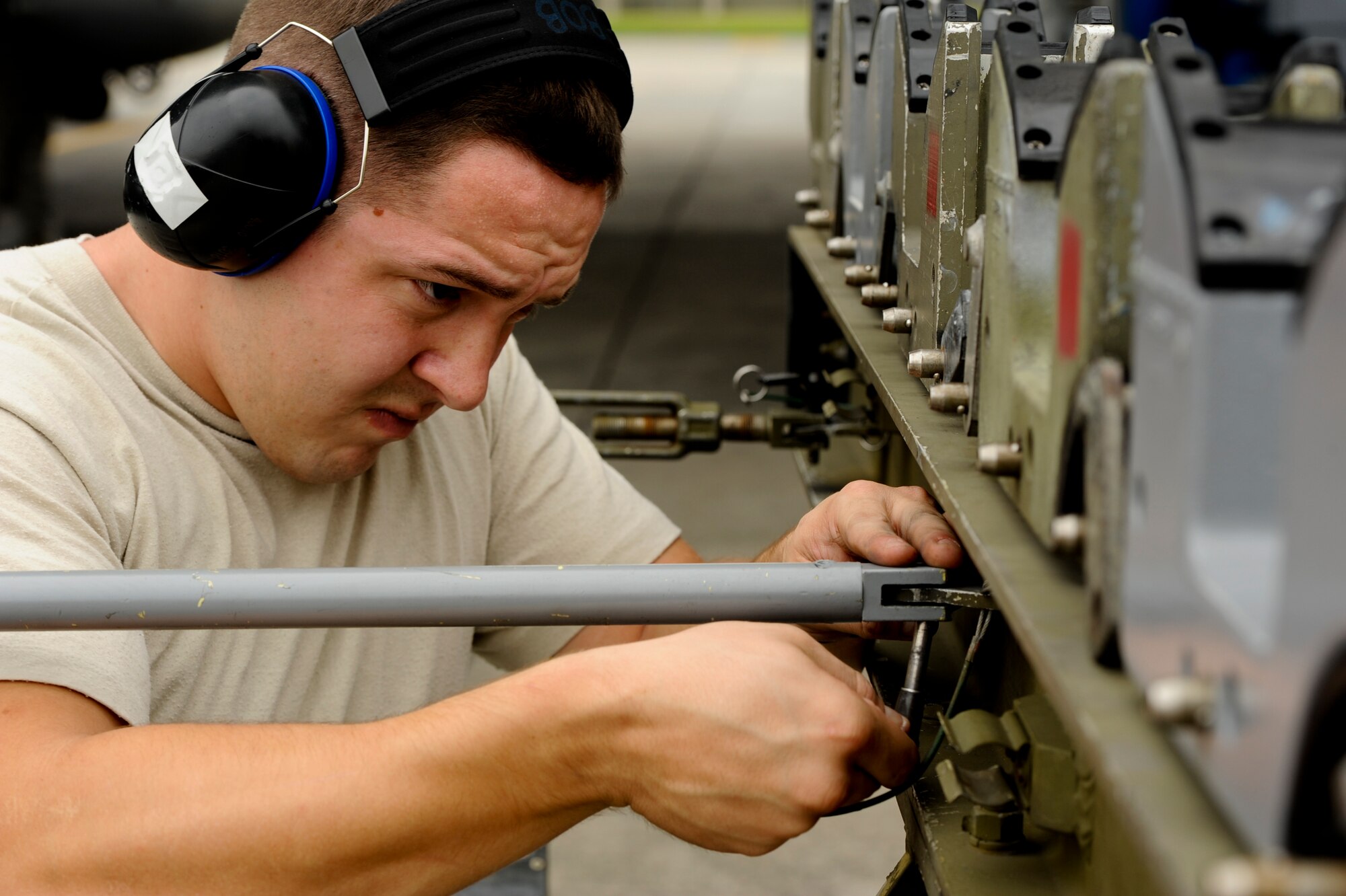 U.S. Air Force Senior Airman Robert Mathews, 67th Aircraft Maintenance Unit weapons load crew member, secures an ammunition trailer during a weapons load competition on Kadena Air Base, Japan, April 5, 2013. Weapons load competitions test Airmen's proficiency through several challenges while training for real-world contingencies. (U.S. Air Force photo by Airman 1st Class Justin Veazie)