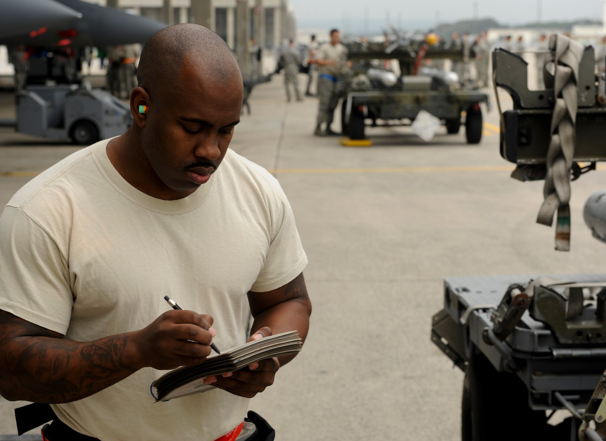U.S. Air Force Staff Sgt. Jamar Hugie, 67th Aircraft Maintenance Unit weapons load crew chief reviews a checklist during a weapons load competition on Kadena Air Base, Japan, April 5, 2013. Weapons load competitions test Airmen's proficiency through several challenges while training for real-world contingencies. (U.S. Air Force photo by Airman 1st Class Justin Veazie)