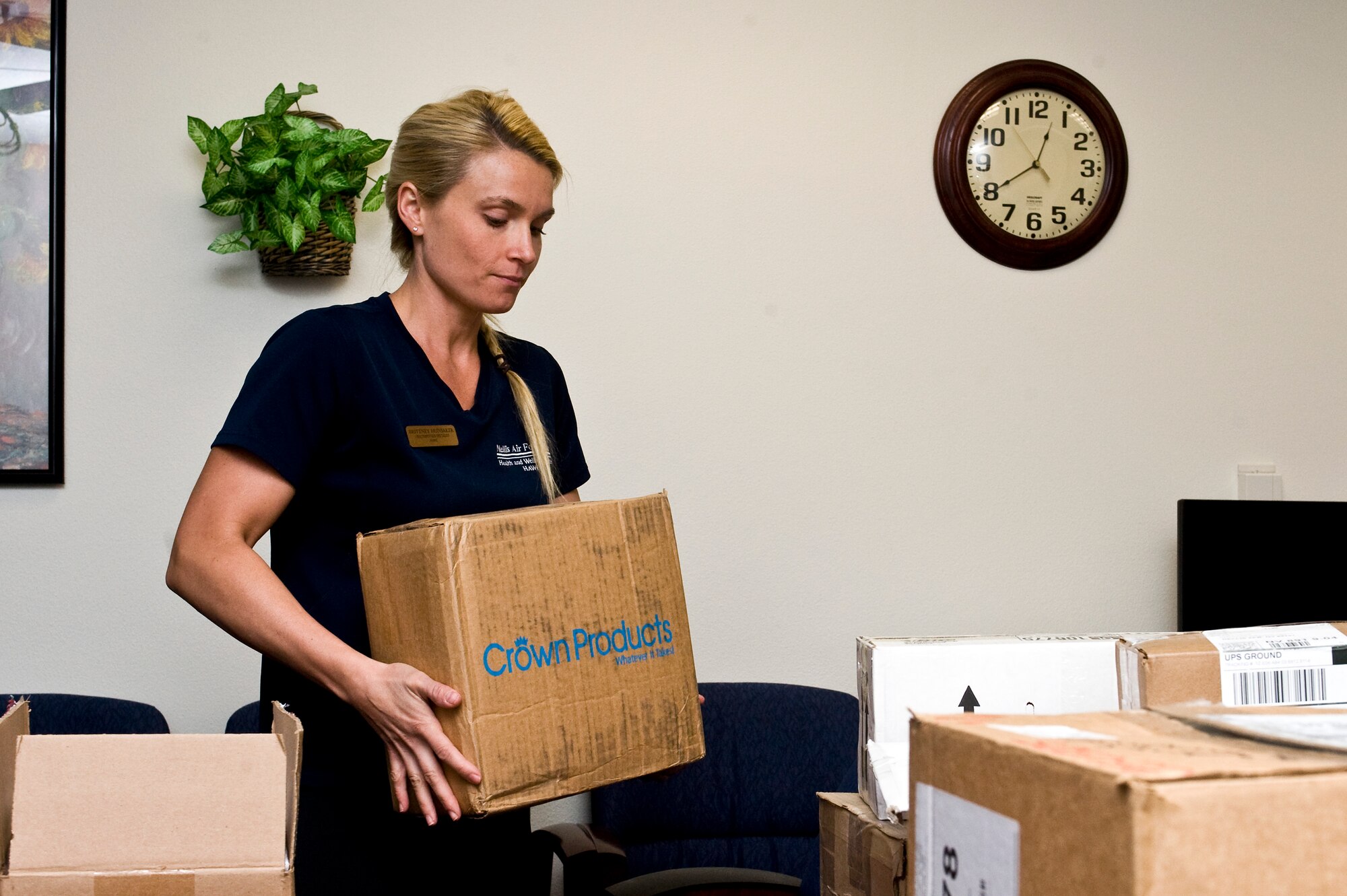 Brittney Hunsaker, 99th Aerospace Medicine Squadron fitness specialist, lifts a box April 9, 2013, at Nellis Air Force Base, Nev.  The move to the Warrior Fitness Center embodies the 99th Air Base Wing’s mission statement; to enable success through innovative base support. (U.S. Air Force Photo by Airman 1st Class Jason Couillard)