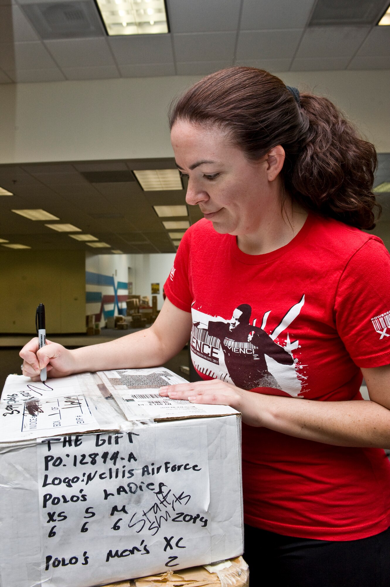 Lacy Puttuck, 99th Aerospace Medicine Squadron nutrition program manager, labels a box April 9, 2013, at Nellis Air Force Base, Nev.  As of April 4th, the Health and Wellness Center is no longer open for workouts and services will be limited during the move to the Warrior Fitness Center. (U.S. Air Force Photo by Airman 1st Class Jason Couillard)