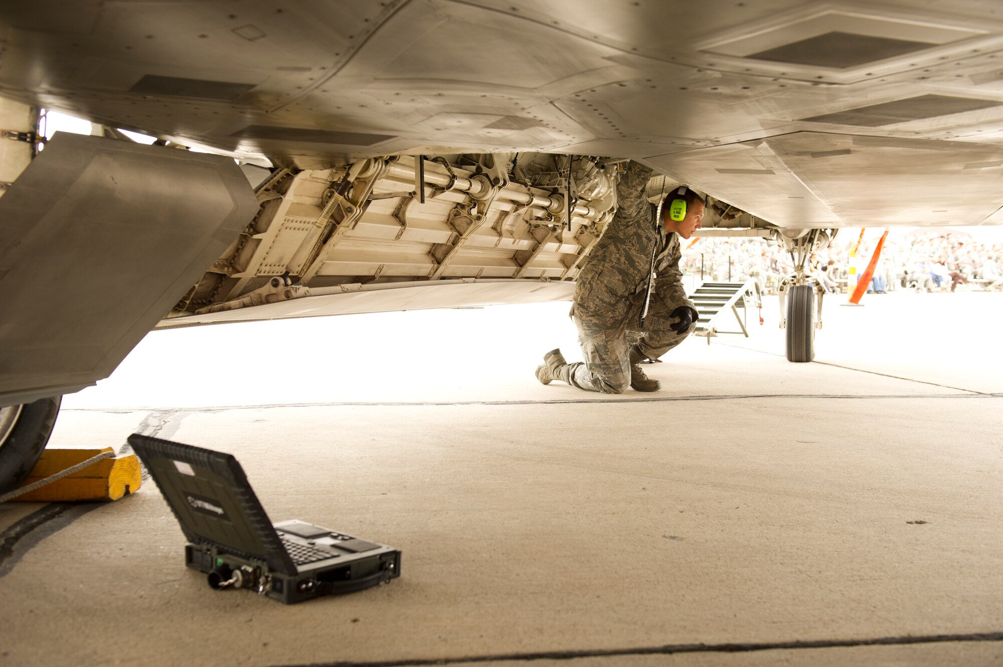 Senior Airman Andrew Guise, 49th Aircraft Maintenance Squadron load team member, readies to load munitions on an F-22 Raptor aircraft during the quarterly load-crew competition at Holloman Air Force Base, N.M., April 5. The F-22 load-crew competed in the load-crew competition to have their skills evaluated alongside the MQ-9 Reaper aircraft and German Air Force load-crews. For the competition, points are awarded during the weapons loading, tool kit inspection, and uniform inspection. (U.S. Air Force photo by Airman 1st Class Michael Shoemaker/Released)
