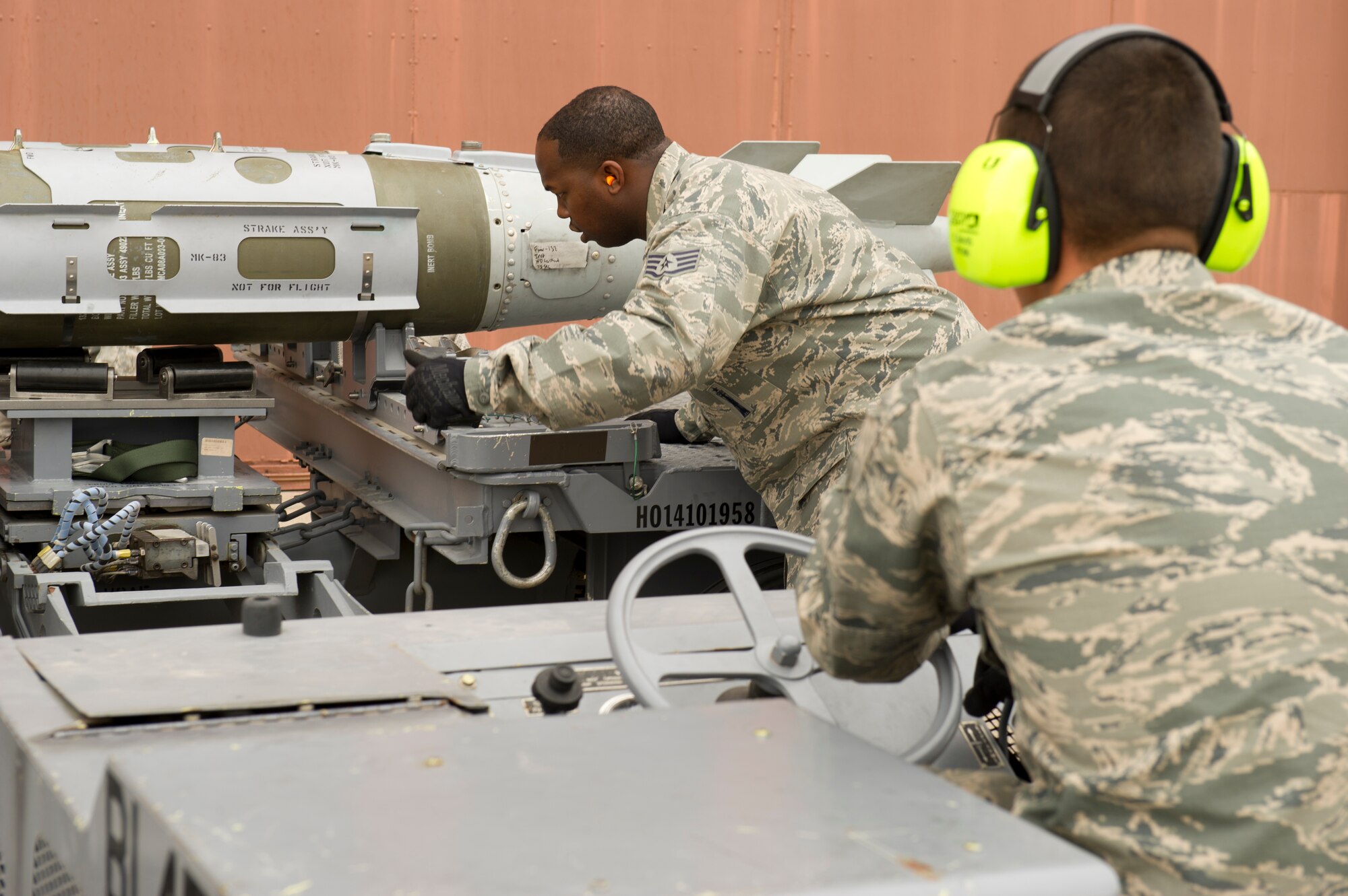 Staff Sgt. Kevin Hagans, 49th Aircraft Maintenance Squadron load team member, directs Senior Airman Chad Davis, 49th Aircraft Maintenance Squadron load team member, while preparing to load a missile onto an F-22 Raptor aircraft during the quarterly load-crew competition at Holloman Air Force Base, N.M., April 5. The F-22 load-crew competed in the load-crew competition to have their skills evaluated alongside the MQ-9 Reaper aircraft and German Air Force load-crews. For the competition, points are awarded during the weapons loading, tool kit inspection, and uniform inspection. (U.S. Air Force photo by Airman 1st Class Michael Shoemaker/Released)