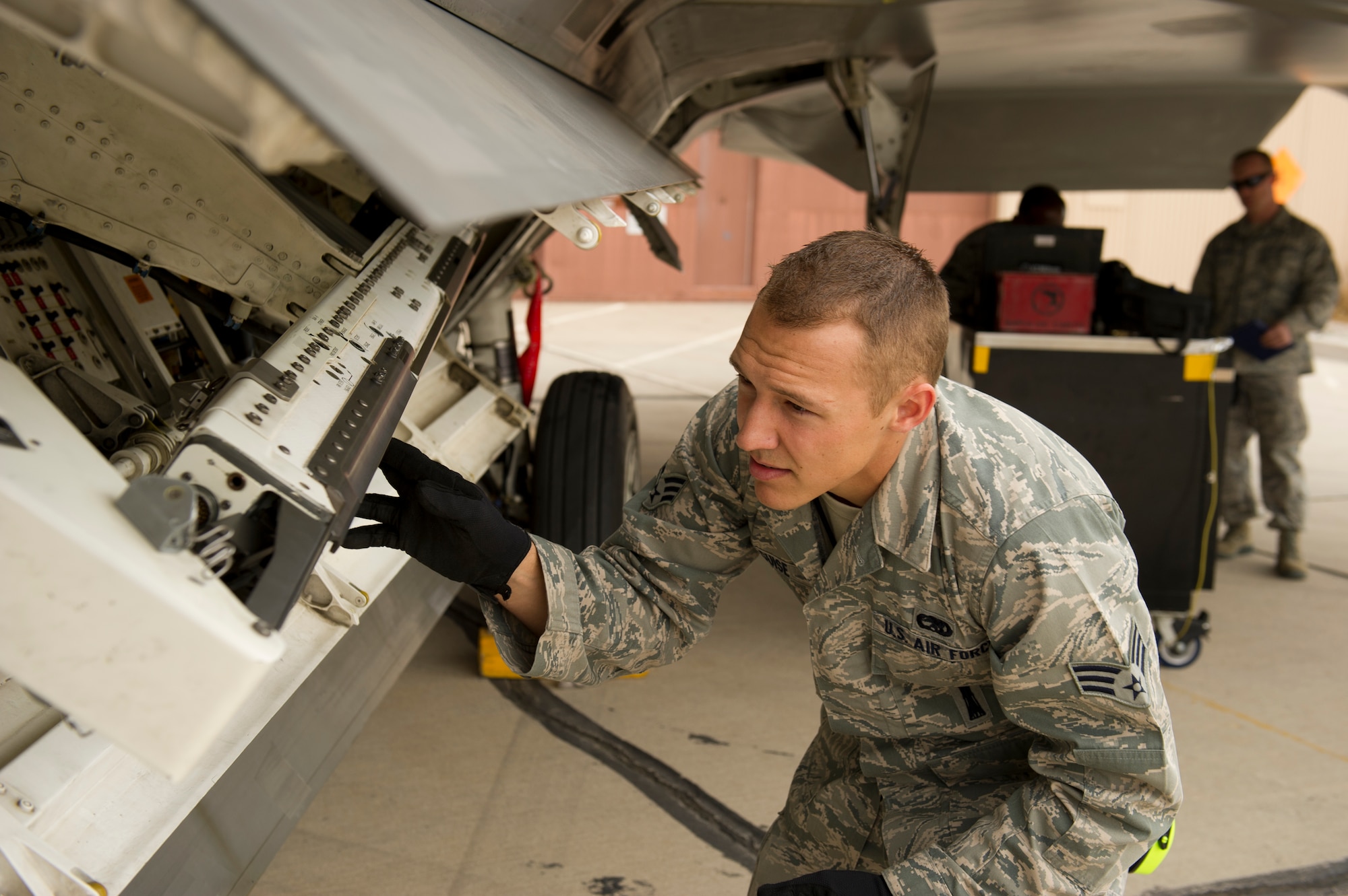 Senior Airman Andrew Guise, 49th Aircraft Maintenance Squadron load team member, checks the connection points on the F-22 Raptor aircraft during the quarterly load-crew competition at Holloman Air Force Base, N.M., April 5. The F-22 load-crew competed in the load-crew competition to have their skills evaluated alongside the MQ-9 Reaper and German Air Force load-crews. For the competition, points are awarded during the weapons loading, tool kit inspection, and uniform inspection. (U.S. Air Force photo by Airman 1st Class Michael Shoemaker/Released)