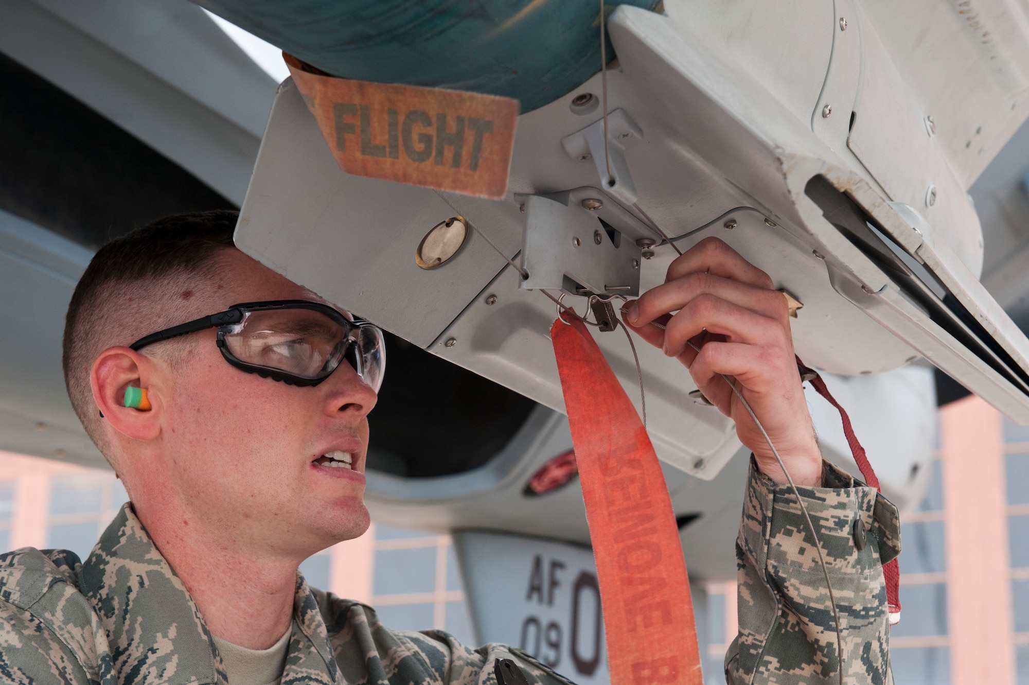 Staff Sgt. Dustin Ford, 849th Aircraft Maintenance Squadron, prepares an MQ-9 Reaper aircraft for weapons-loading during a quarterly load-crew competition at Holloman Air Force Base, N.M., April 5. The MQ-9 load-crew competed in the competition to have their skills evaluated alongside the F-22 Raptor aircraft and German Air Force load-crews. For the competition, points are awarded during the weapons-loading, tool kit inspection, and uniform inspection. (U.S. Air Force photo by Airman 1st Class Leah Murray/Released)