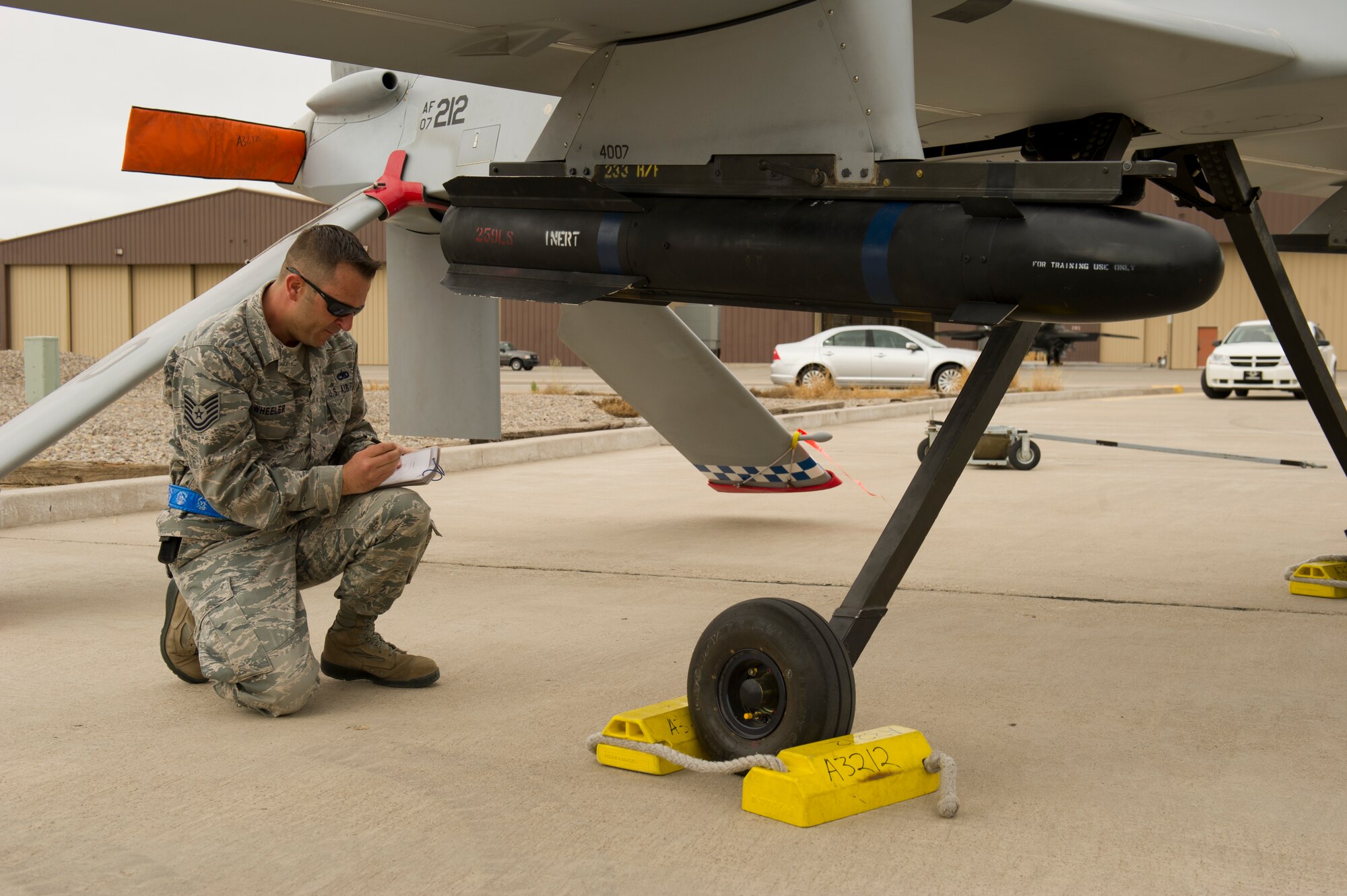 Technical Sgt. Travis Wheeler, 849th Aircraft Maintenance Squadron load team member, reviews his checklist on an MQ-1 Predator aircraft during the load-crew competition at Holloman Air Force Base, N.M., April 5. Load-crew competitions are held on a quarterly basis and are used to help build morale through friendly competition. (U.S. Air Force photo by Airman 1st Class Michael Shoemaker/Released)