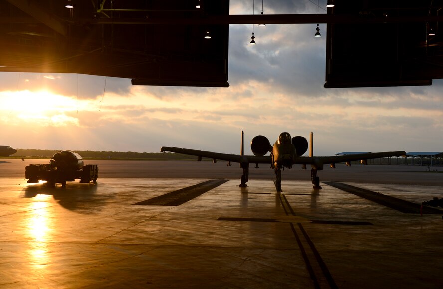 An A-10 Thunderbolt II sits in a hangar as the sun rises on Barksdale Air Force Base, La., April 9, 2013. The A-10 is equipped with one 30 mm GAU-8/A seven-barrel Gatling Gun capable of firing 3,900 rounds per minute to defeat a wide variety of targets including tanks. (U.S. Air Force photo/Senior Airman Micaiah Anthony) 