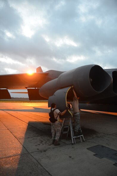 Airman 1st Class Jonathan Dinsmore and Airman 1st Class John Aliberti, 2nd Maintenance Squadron, install an engine cowling to a B-52H Stratofortress on Barksdale Air Force Base, La., April 9, 2013. Cowlings are often removed so maintainers can inspect or work on the engine. (U.S. Air Force photo/Senior Airman Micaiah Anthony)