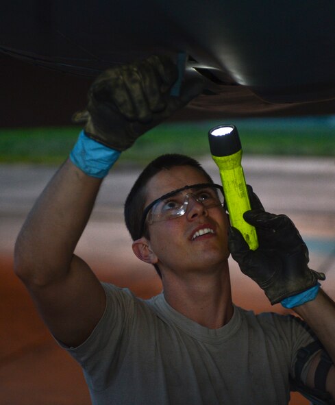 Airman 1st Class Jonathan Dinsmore, 2nd Maintenance Squadron, closes a latch on an engine cowling of a B-52H Stratofortress on Barksdale Air Force Base, La., April 9, 2013. Engine cowlings are used to protect the aircraft's engines from the elements. (U.S. Air Force photo/Senior Airman Micaiah Anthony)