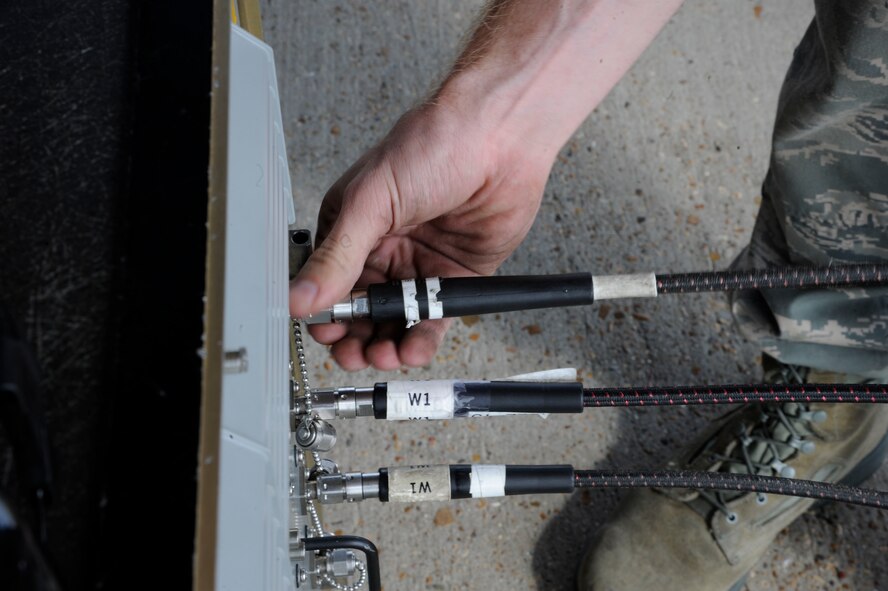 Airman 1st Class Sam Ritzman, 2nd Maintenance Squadron Avionics, plugs in cables to a 464 test stand during testing of the electronic countermeasures on a B-52H Stratofortress on Barksdale Air Force Base, La., April 9, 2013. Avionics Airmen maintain and test the countermeasure systems to ensure the B-52 can evade and disrupt enemy attacks directed toward it by deploying flares or jamming radar. (U.S. Air Force photo/Airman 1st Class Andrew Moua)