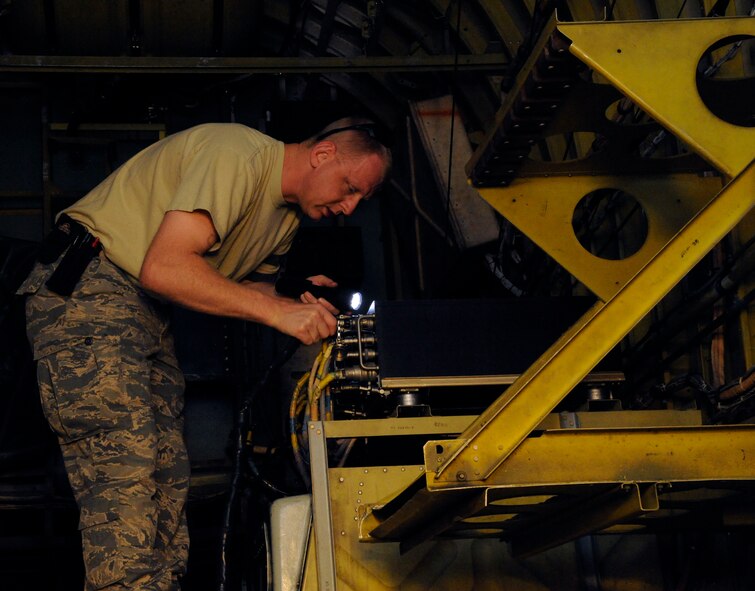 Tech. Sgt. Thomas White, 707th Maintenance Squadron, connects power cables to a pressure test set on a B-52H Stratofortress on Barksdale Air Force Base, La., April 9, 2013. The test checks for the proper pressure levels within the B-52's electronic countermeasures as the system needs a certain amount of pressure to keep moisture and dirt out, which could cause damage. (U.S. Air Force photo/Airman 1st Class Andrew Moua)