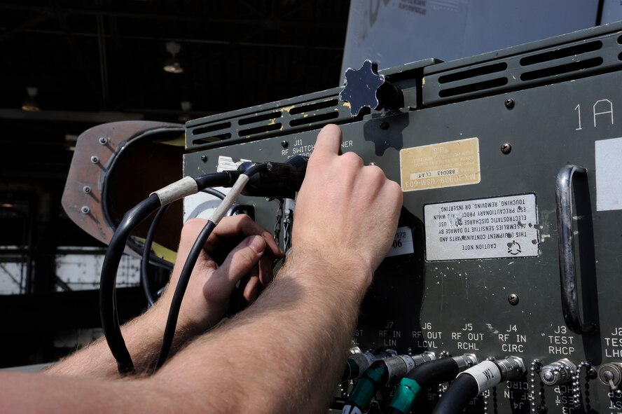 Airman 1st Class Sam Ritzman, 2nd Maintenance Squadron Avionics, plugs cords into a Radio Frequency Interface Unit on a B-52H Stratofortress on Barksdale Air Force Base, La., April 9, 2013. The RFI-U simulates radio frequencies which the B-52s electronic countermeasures pick up and jam or disrupt accordingly. The signals jammed by the ECMs let avionics Airmen know whether the system is functioning properly. (U.S. Air Force photo/Airman 1st Class Andrew Moua)