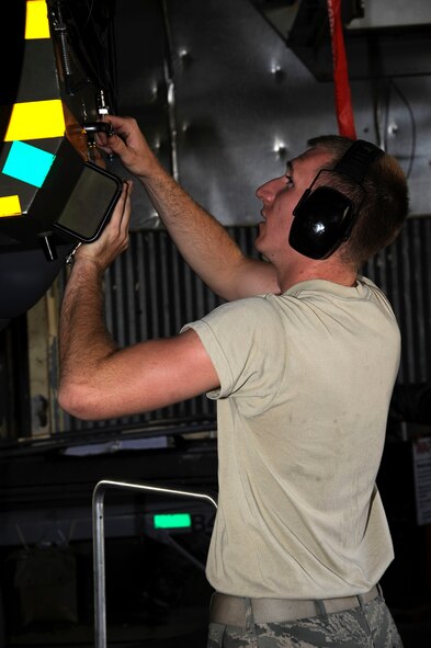 Airman 1st Class Sam Ritzman, 2nd Maintenance Squadron Avionics, inspects a coupling during testing of electronic warfare systems on a B-52H Stratofortress on Barksdale Air Force Base, La., April 9, 2013. The coupling tests the ECMs by simulating different radio frequencies and the Airmen check to see whether the ECMs are properly jamming or disrupting the simulated frequencies to determine the status of the electronic warfare systems. (U.S. Air Force photo/Airman 1st Class Andrew Moua)