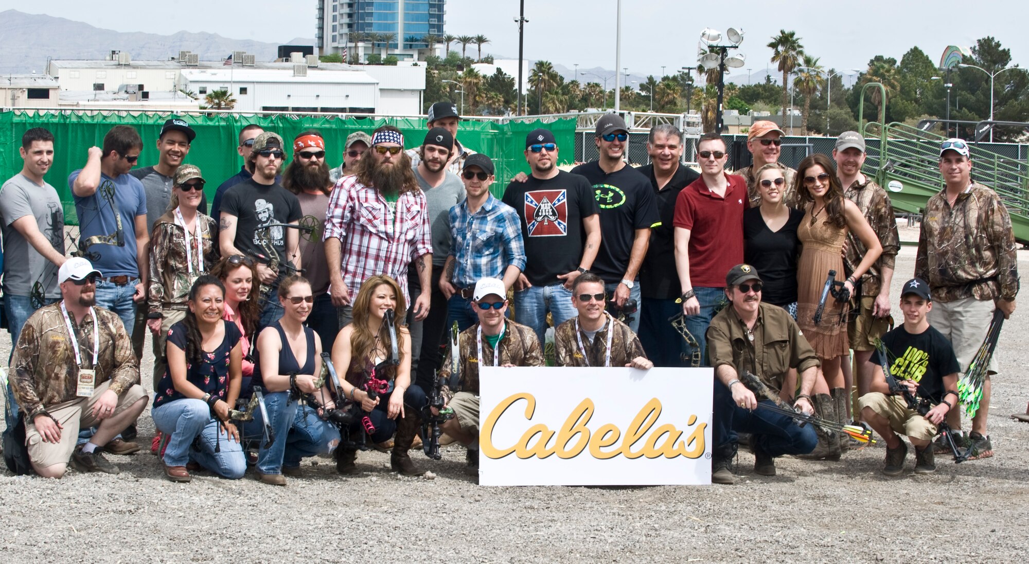 The participants of the Academy of Country Music and Cabela’s Great Outdoors Archery Event pose for a group photo April 6, 2013, in Las Vegas. The participates included military members from Nellis Air Force Base, Cabela representatives, country music stars and A&E's "Duck Dynasty" stars. (U.S. Air Force photo by Senior Airman Matthew Lancaster)