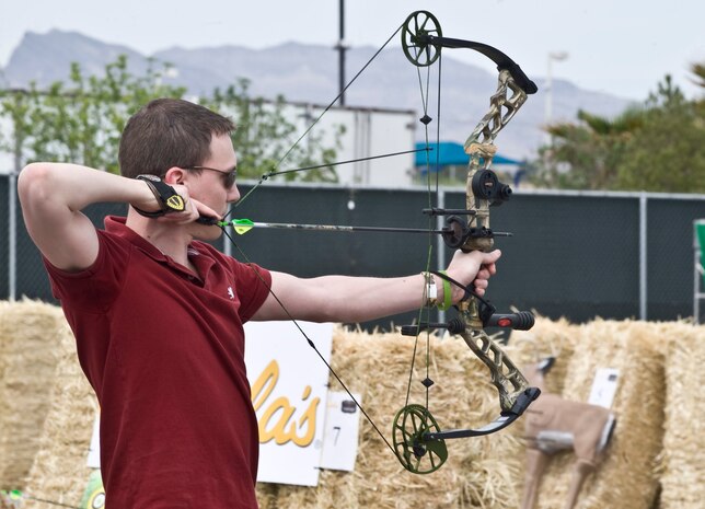 Senior Airman Travis Michel, 99th Force Support Squadron assignments counselor, prepares to shoot an arrow at the Academy of Country Music and Cabela’s Great Outdoors Archery Event April 6, 2013, in Las Vegas. The archery event tests participants’ skills and knowledge on bow hunting, using Cabela's state-of-the-art archery equipment. (U.S. Air Force photo by Senior Airman Matthew Lancaster)