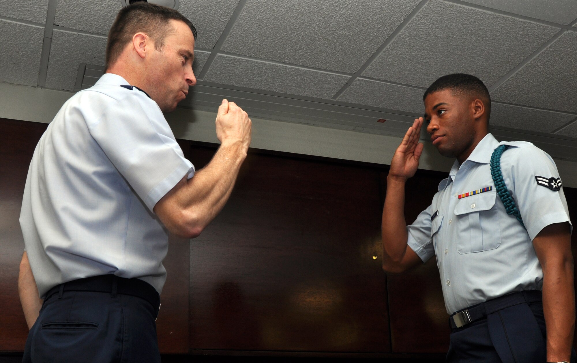 GOODFELLOW AIR FORCE BASE, Texas – Airman 1st Class Kenneth Shipp, 315th Training Squadron student, salutes Col. Thomas Schmidt, 17th Training Wing Vice Commander, after receiving his teal rope at the Professional Development Center, here, April 8. Shipp was among the first group of 27 students to receive teal ropes at Goodfellow. (U.S. Air Force photo/ Airman 1st Class Joshua Edwards)