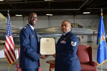 U.S. Air Force Tech. Sgt. Brian Racy, 79th Fighter Squadron specialist section expediter, receives a certificate of retirement from Maj. Herman Fredrick at Shaw Air Force Base, S.C., April 5, 2013.  Before retiring as a “Tiger,” Racy served the Air Force for 20 years.  (U.S. Air Force photo by Airman 1st Class Nicole Sikorski/Released) 