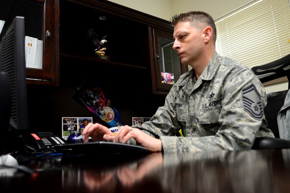U.S. Air Force Senior Master Sgt. Robert Drown, 20th Security Forces Squadron logistics superintendent, works at his computer at Shaw Air Force Base, S.C., March 25, 2013.  Drown, accompanied by his wife Sheila, was the winner of the Football Frenzy, a 20th Force Support Squadron and Air Force Clubs sponsored event.    The raffle had more than 20,000 applicants and he was one of four to be selected to enjoy an all-expenses paid trip to the game.  (U.S. Air Force photo by Airman 1st Class Nicole Sikorski/Released)