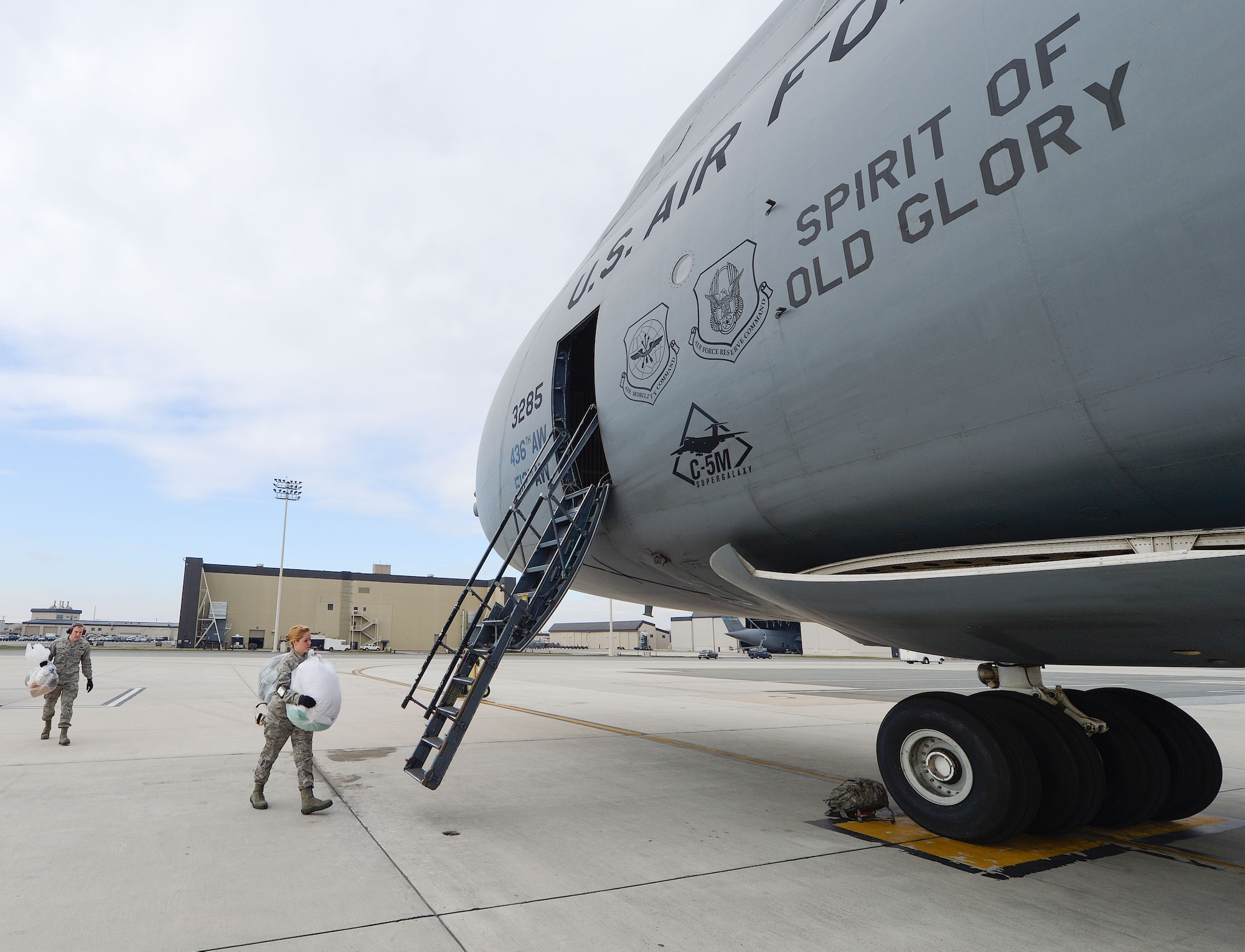 Clean fleet servicing is usually done hours before a cargo mission is ready to go. Here, airmen from the 436th Aerial Port Squadron, clean fleet section, move consumable items from their transport van to the C-5M Super Galaxy aircraft from the 436th Airlift Wing, Dover Air Force Base, Del. The 436th Aerial Port Squadron, clean fleet services section, works out of the passenger terminal and is shown in-action March 28, 2013. (U.S. Air Force photo/Greg L. Davis)