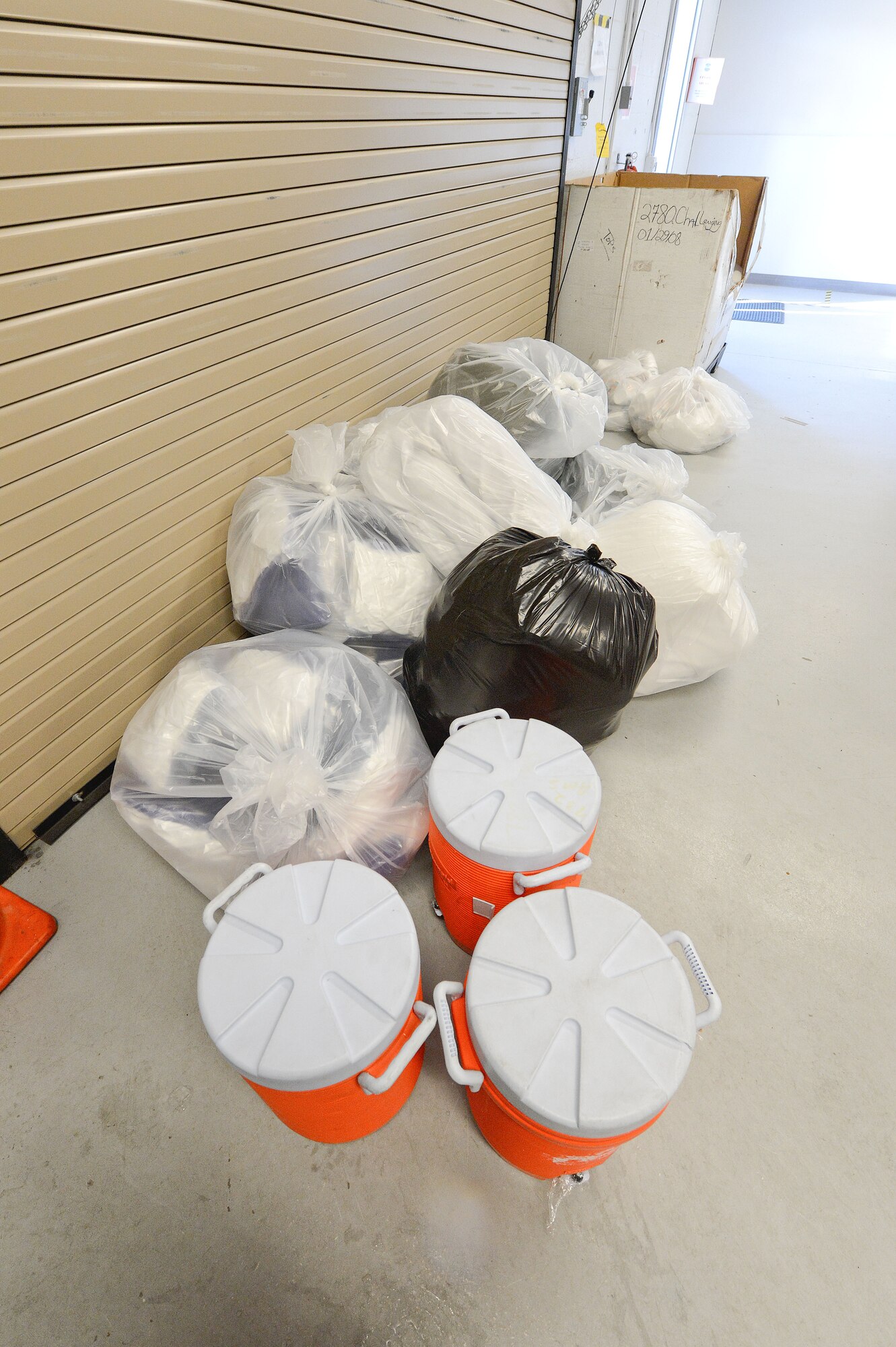 Consumable items such as water, earplugs, and trash bags along with blankets and pillows are piled together before being taken out to service a C-5M Super Galaxy from the 436th Airlift Wing, Dover Air Force Base, Del. The 436th Aerial Port Squadron, clean fleet services section, works out of the passenger terminal and is shown in-action March 28, 2013. (U.S. Air Force photo/Greg L. Davis)