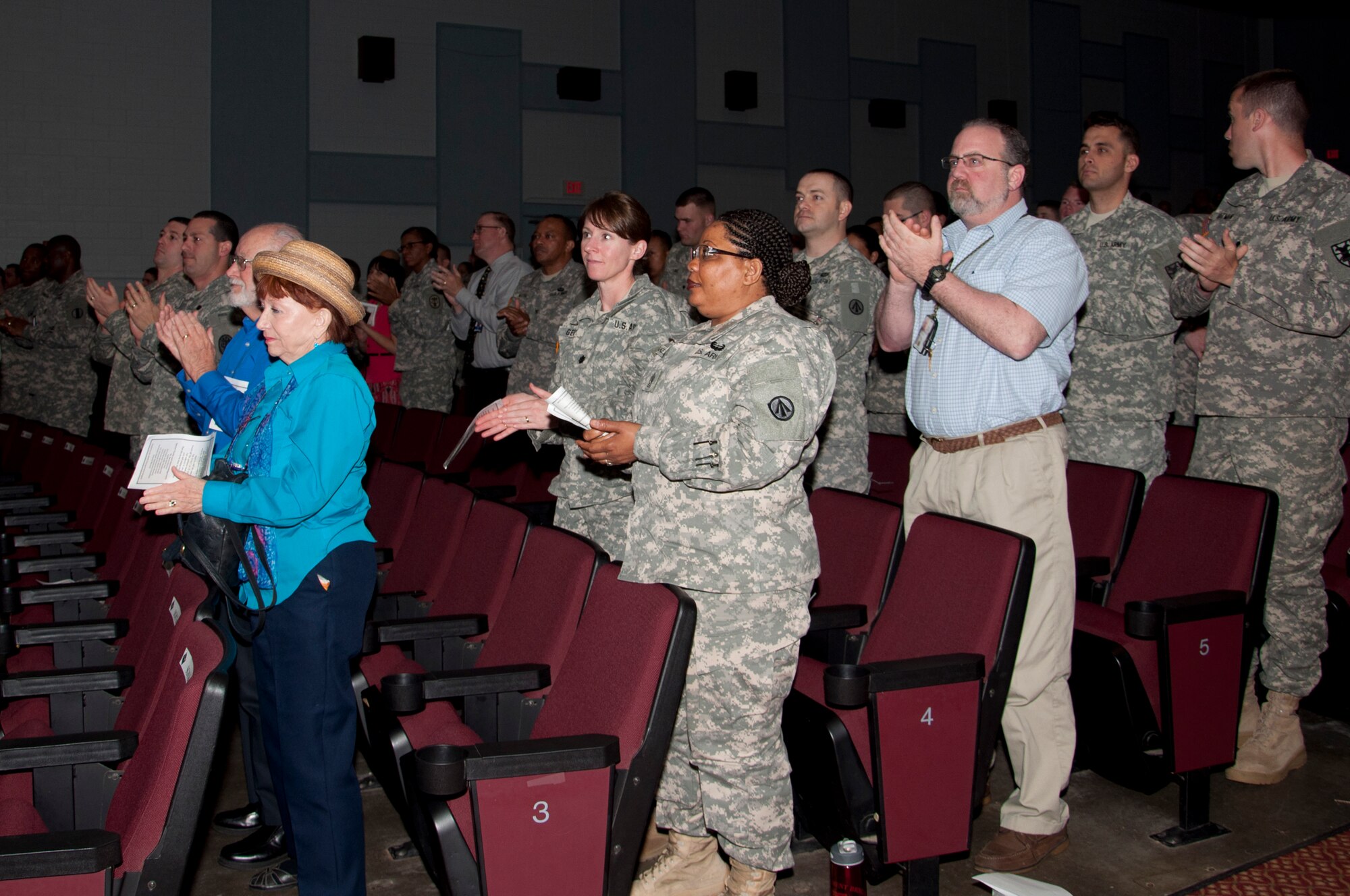 Audience members give Berna Heyman a round of applause during the 2013 Holocaust Days of Remembrance at Jacobs Theater on Fort Eustis, Va., April 9, 2013. Attendees learned about Heyman’s family and how they survived the Holocaust. (U.S. Air Force photo by Tech. Sgt. April Wickes/Released)