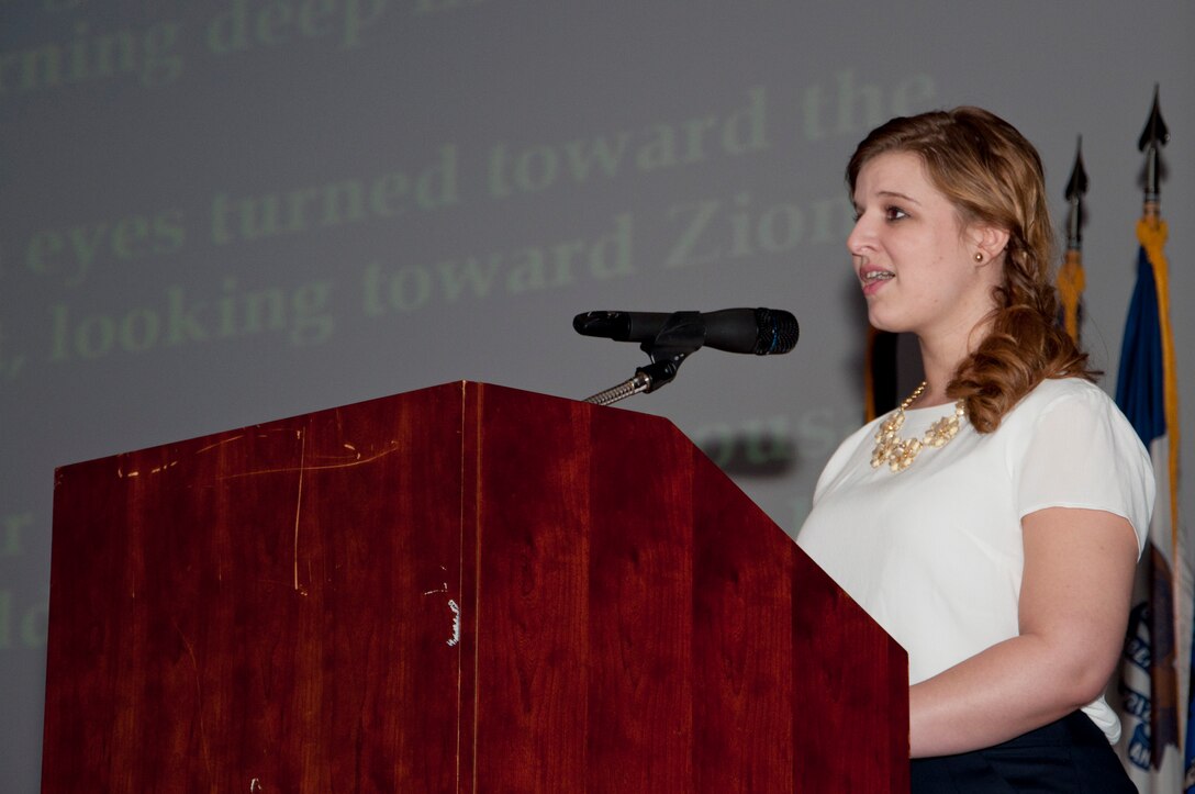 Megan Alpert, 733rd Mission Support Group installation sexual assault victim advocate, sings “HaTikvah,” a Jewish folklore song, during the annual Holocaust Days of Remembrance at Jacobs Theater on Fort Eustis, Va., April 9, 2013. The title is Hebrew for “The Hope,” and is the national anthem of Israel. (U.S. Air Force photo by Tech. Sgt. April Wickes/Released) 