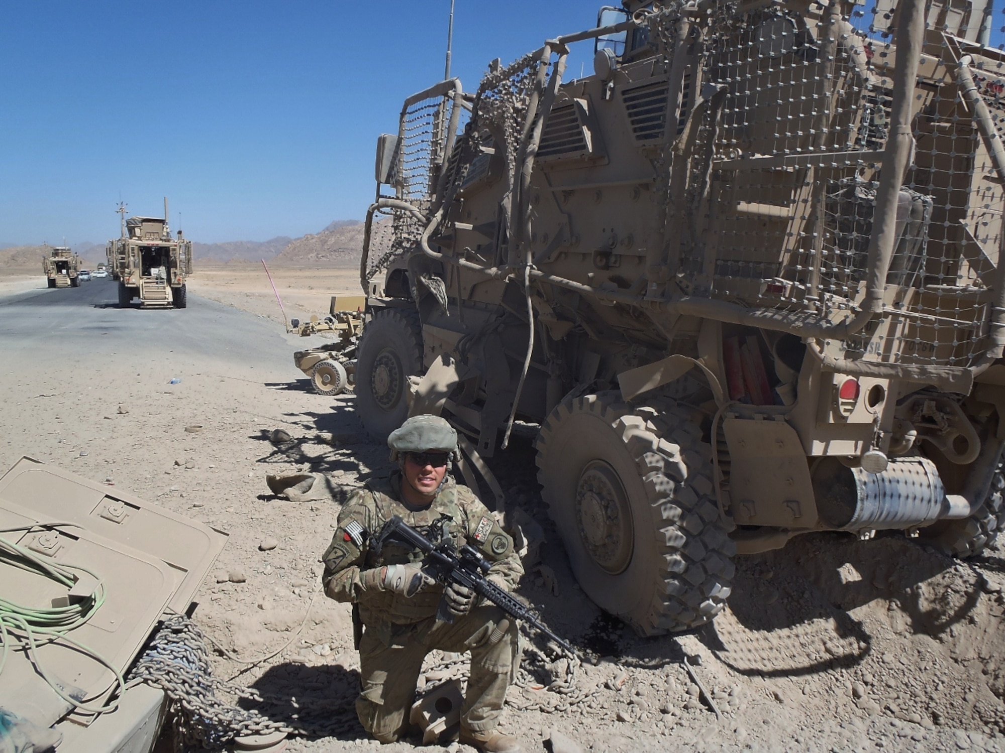 Senior Airman Daniel Shimanski, 436th Medical Operations Squadron emergency medical technician, poses for a photo in front of vehicle Sept. 28, 2012, in Afghanistan. Shimanski was awarded the Air Force Combat Action Medal for his service during the deployment. (Courtesy photo)