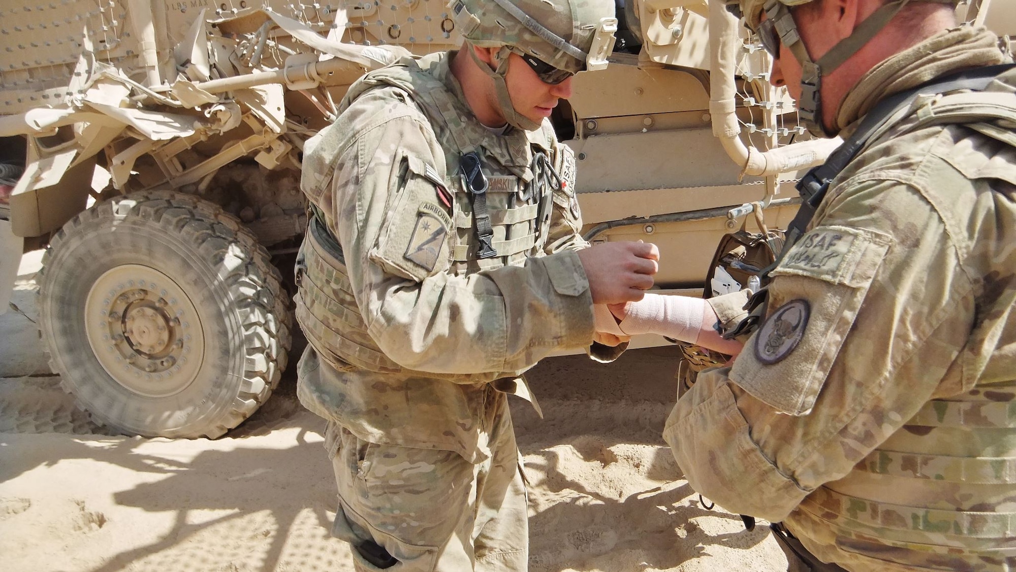 Senior Airman Daniel Shimanski, 436th Medical Operations Squadron emergency medical technician, treats a wounded soldier after an Improvised Explosive Device struck his vehicle Sept. 28, 2012, in Afghanistan. Shimanski received the Air Force Combat Action Medal for his service during the deployment. (Courtesy photo)