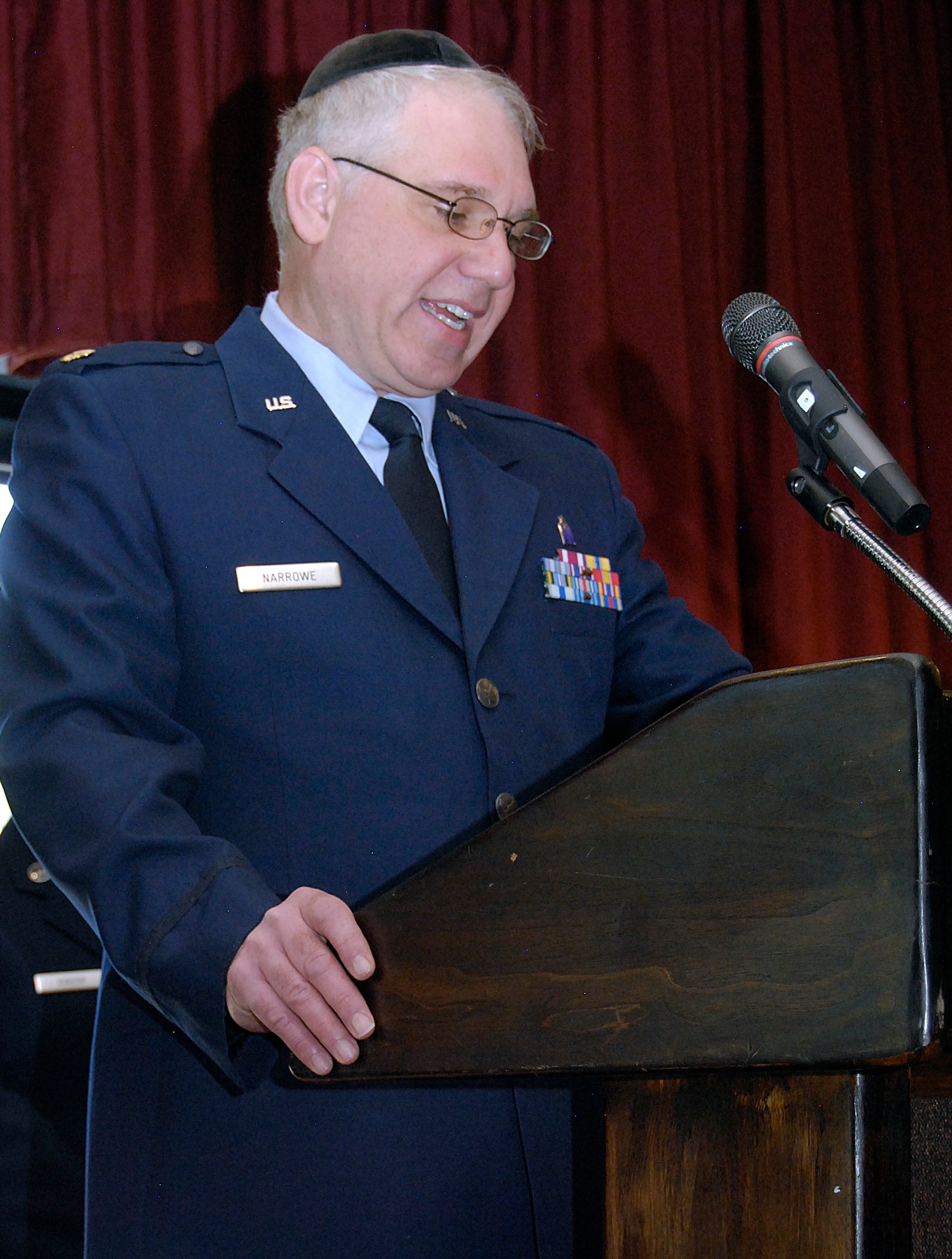 Chaplain (Maj.) Joshua Narrowe delivers an invocation at the Air Force Academy's Holocaust Remembrance Day observance in the Falcon Club April 8, 2013. Narrowe is the Academy's Jewish chaplain. David Bram, a Holocaust survivor, spoke at the event. (U.S. Air Force photo/Don Branum)