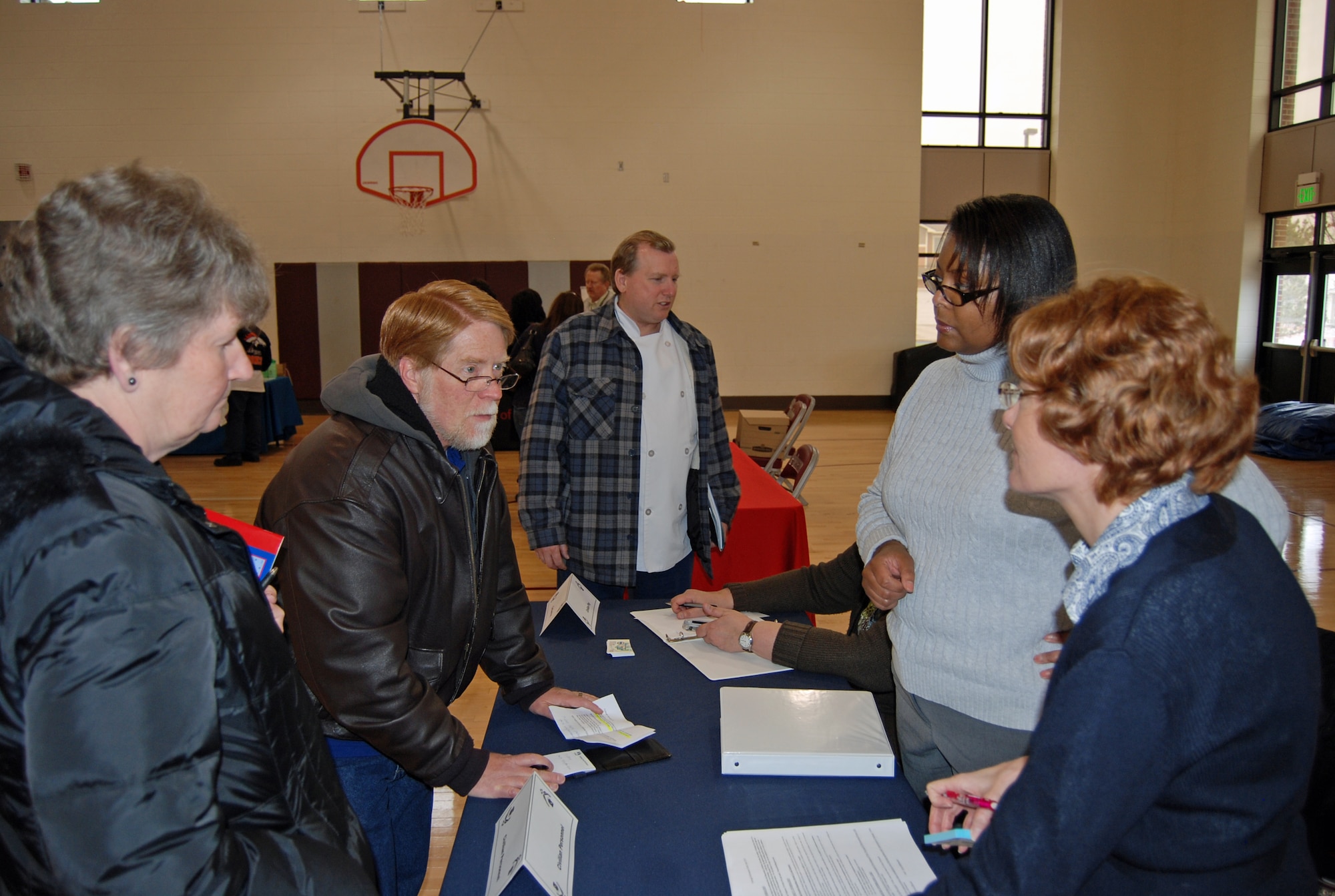 PETERSON AIR FORCE BASE, Colo. – Connie Knight (left), 21st Contracting Squadron, and Bret Duryee, 21st Program Management Division, get information from Ellen Summers (right) and Roxanne McClain, civilian personal representatives, at the 21st Force Support Squadron Furlough Fair held 10 a.m.-2 p.m. April 2 for civilian employees. The fair, held at the R.P. Lee Youth Center, included a financial briefing and representatives from civilian personnel, mental health, the military and family life consultant, child and youth programs, the American Red Cross, financial management, Five Star Bank, ENT Credit Union, Colorado Springs Consumer Credit Counseling Services, Colorado Springs Utilities, Pikes Peak Work Force, Pikes Peak Library District, Pikes Peak United Way, Peak Military Care Network, and Operation Home Front. For the latest furlough information, go to the 21st Space Wing SharePoint page. (U.S. Air Force photo/Steve Brady)