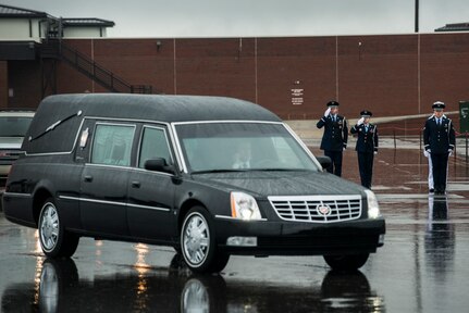 Members of the Joint Base Charleston Honor Guard salute as the funeral procession for U.S. Army Chief Warrant Officer 5th Class Curtis Reagan, 43, of Summerville, S.C departs April 4, 2013, at Joint Base Charleston – Air Base, S.C. Reagan died March 29, 2013, in Kandahar, Afghanistan, from a non-combat related illness. Reagan’s remains were flown from Dover, Del., to Charleston. (U.S. Air Force photo/ Senior Airman George Goslin)(RELEASED)