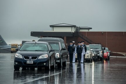 Members of the Joint Base Charleston Honor Guard stand at attention before the funeral procession for U.S. Army Chief Warrant Officer 5th Class Curtis Reagan, 43, of Summerville, S.C departs April 4, 2013, at Joint Base Charleston – Air Base, S.C. Reagan died March 29, 2013, in Kandahar, Afghanistan, from a non-combat related illness. Reagan’s remains were flown from Dover, Del., to Charleston. (U.S. Air Force photo/ Senior Airman George Goslin)(RELEASED)