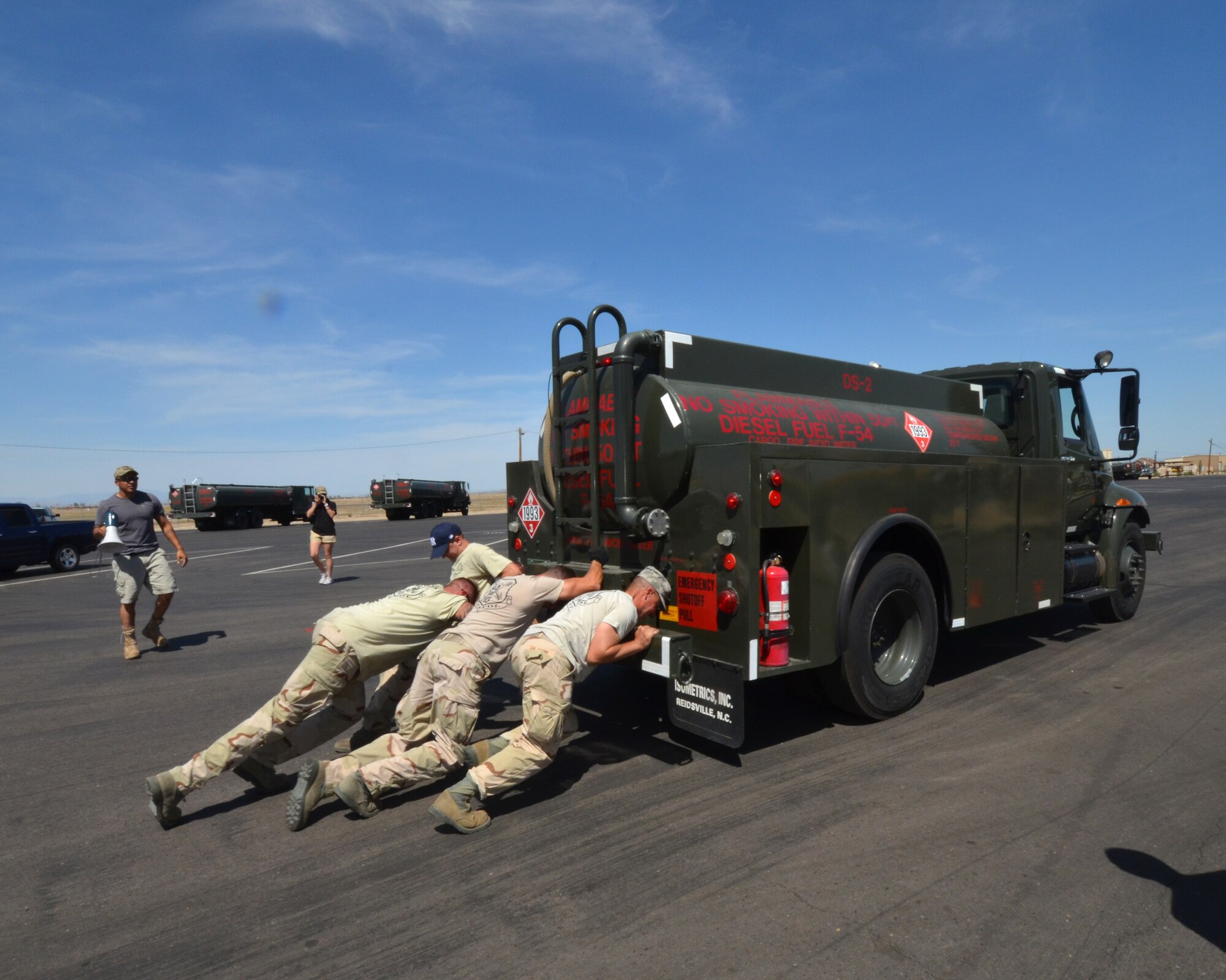 Tech. Sgt. Shannon Cottrill, Staff Sgt. Donovan Walden, Tech. Sgt. Daniel Martin and Staff Sgt. Matthew Salamone of the 161st Air Refueling Wing, Petroleum, Oil and Lubricants team push an Oshkosh R-11 fuel tanker during the POL “Roadeo” held, Saturday April 6, at Luke Air Force Base, Glendale, Ariz. This event was a tie breaker between the 161 ARW and Luke AFB, to determine this year's winner. (U.S. Air Force photo by Senior Airmen Rashaunda Williams/Released)