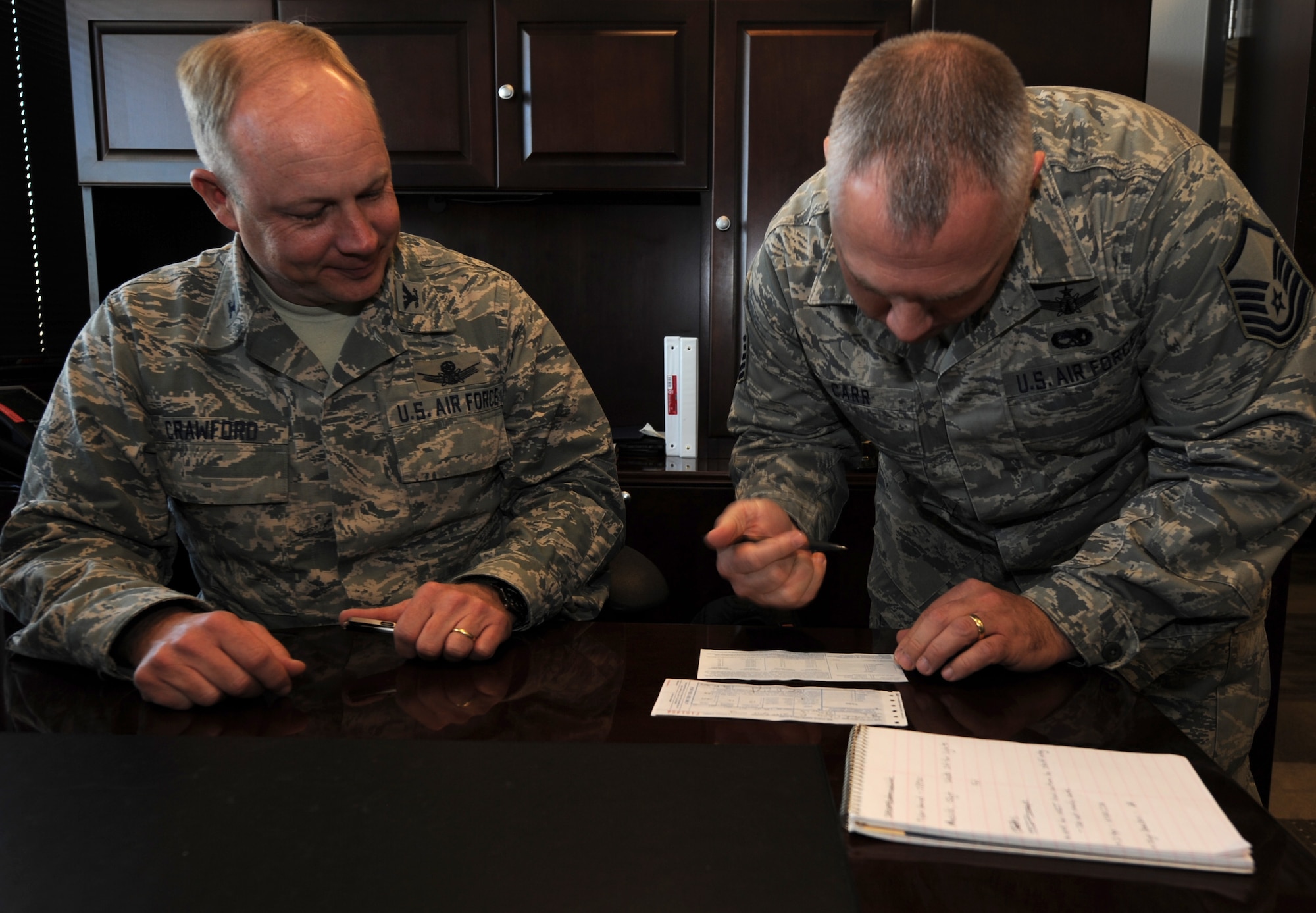 PETERSON AIR FORCE BASE, Colo. -- Master Sgt. David Carr, NCOIC of Inspections Branch, 21st Operations Group Standardization and Evaluation, finalizes an Air Force Assistance Fund donation form for Col. Chris Crawford, 21st Space Wing commander, March 25. The AFAF is an annual effort to raise funds to support Air Force active duty, retirees, Reservists, Guard members and their families in need. This year’s campaign continues until May 3 with the goal of raising $92,814. All personnel, military, civilians and contractors, may participate in the AFAF campaign and can contact their unit’s AFAF project officer to make a donation. Additional information can be found at www.afassistancefund.org. (U.S. Air Force photo/Staff Sgt. James Breeden)