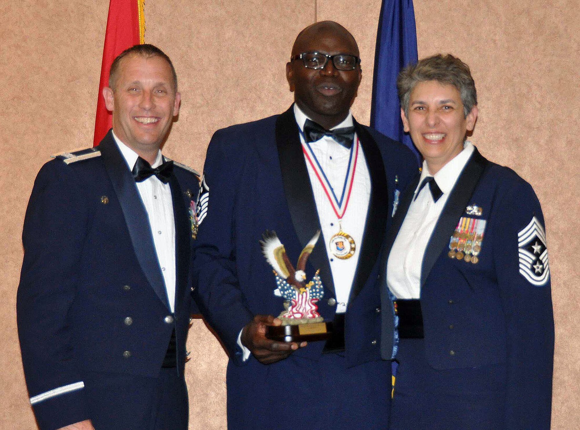 TRAVIS AIR FORCE BASE, Calif. -- Master Sgt. Roderick D. Lee, with the 349th Medical Squadron received the 349th Air Mobility Wing First Sergeant of the Year award on March 25, 2013. Col. Matthew Burger 349th AMW Commander and Chief MSgt. Sandra Santos, 349th AMW Command Chief presented the award. (U.S. Air Force photo / Senior Airman Cindy G. Alejandrez)