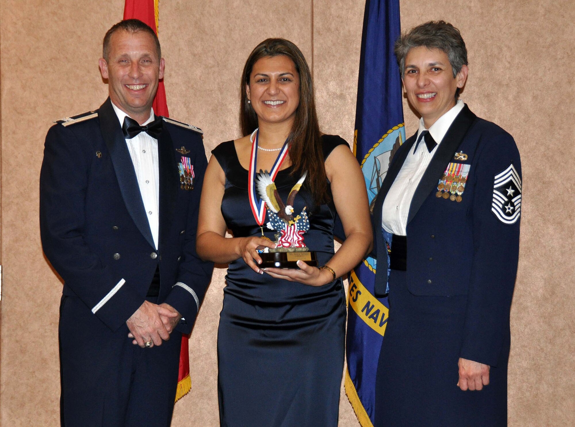 TRAVIS AIR FORCE BASE, Calif. -- Ms. Teresa Serrano, a civilian employee with the 45th Aerial Port Squadron received the 349th Air Mobility Wing, Civilian of the Year award for second category on behalf of Col. Matthew Burger and Chief MSgt. Sandra Santos on March 23, 2013. (U.S. Air Force photo / Senior Airman Cindy G. Alejandrez)