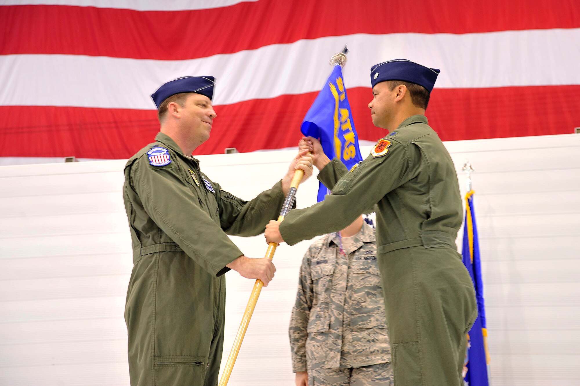 LAS VEGAS, Nev. – Col. John Breeden, 926th Group Commander, left, passes the guidon to Lt. Col. Joseph during the 91st Attack Squadron activation ceremony April 5, 2013. Flying MQ-1B Predator and MQ-9 Reaper remotely piloted aircraft, the 91st ATKS conducts worldwide operations enabling persistent, real-time intelligence, surveillance and reconnaissance. (U.S. Air Force photo by Senior Master Sgt. P.H.)