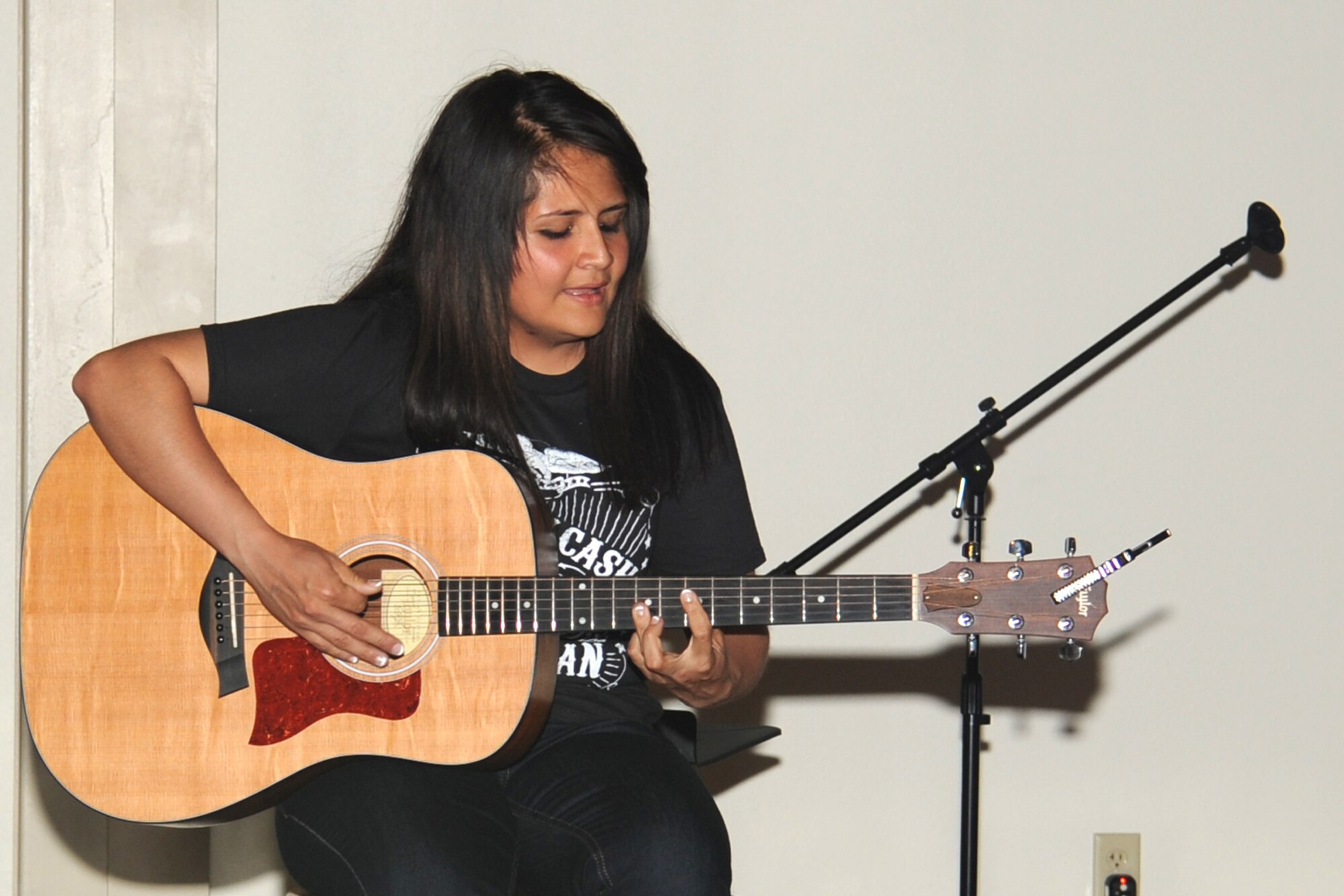 GOODFELLOW AIR FORCE BASE, Texas-- Airman 1st Class Breana Alvarez, 315th Training Squadron student, plays the guitar during the Crossroads talent show on base April 6. Alvarez took first place. (U.S. Air Force photo/ Staff Sgt. Laura R. McFarlane)
