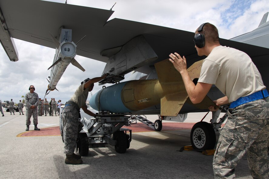 From right: Senior Airman Stephen Hoffler and Staff Sgt. Danessa Gali, both of the 495th Fighter Group, Detachment 93, prepare to load a bomb onto an F-16 during the 482nd Aircraft Maintenance Squadron’s Quarterly Load Crew Competition at Homestead Air Reserve Base, Fla., April 7. The load crews were evaluated in four areas to determine the winner: dress and personal appearance, tool kit inspection, a general knowledge test, and actual munitions loading to include speed and proficiency. (U.S. Air Force photo/Tech. Sgt. Leo Castellano)
