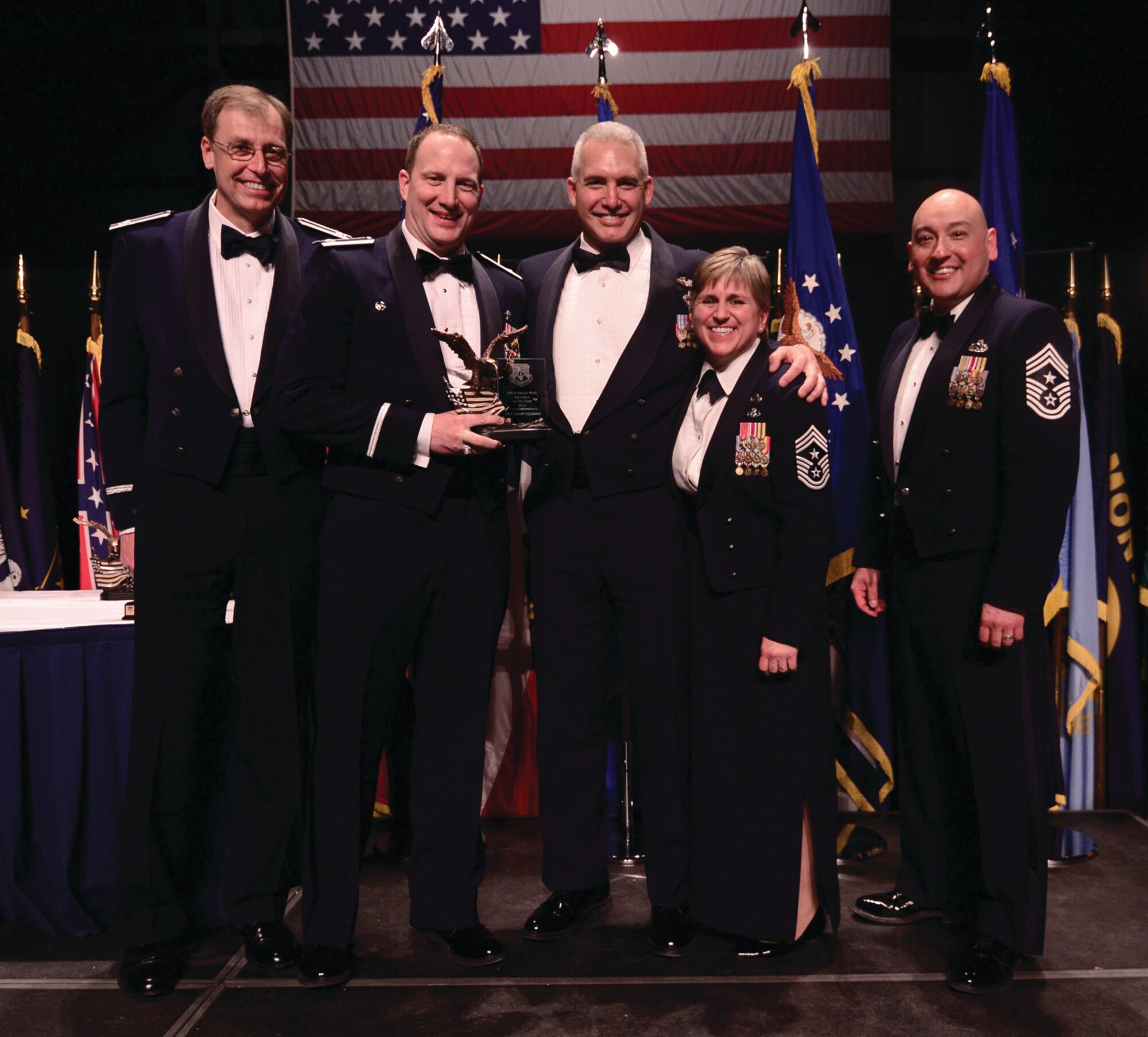 WRIGHT-PATTERSON AIR FORCE BASE, Ohio – The 89th Airlift Squadron was recognized as the 445th Airlift Wing 2012 Squadron of the Year. Accepting the award from Col. Stephen Goeman, 445th AW commander, are Lt. Col. Mitch Richardson, 89th AS commander, and Master Sgt. Steve Rhodes, 89th AS first sergeant. Chief Master Sgts. Peri Rogowski, 445th AW command chief, and Jose Barraza, 3rd Wing command chief, look on. (U.S. Air Force photo/Staff Sgt. Mikhail Berlin)
