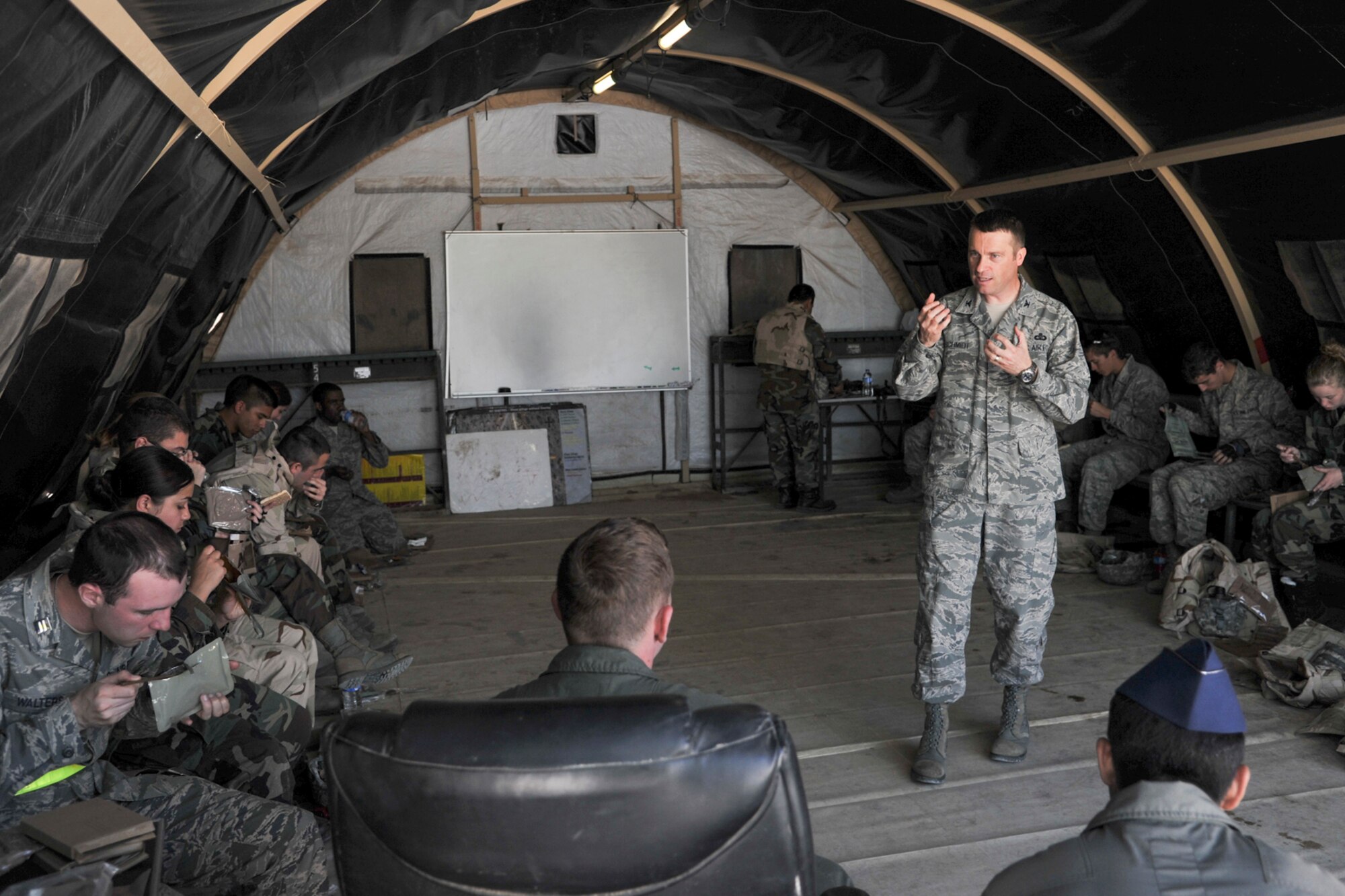GOODFELLOW AIR FORCE BASE, Texas-- Col. Thomas Schmidt, 17th Training Wing vice commander, answers questions asked by Angelo State University ROTC during a field training exercise at Camp Sentinel April 6. The ASU cadets participated in the training to learn expeditionary war skills from manning an entry control point to searching a detainee. (U.S. Air Force photo/ Airman 1st Class Michael Smith)