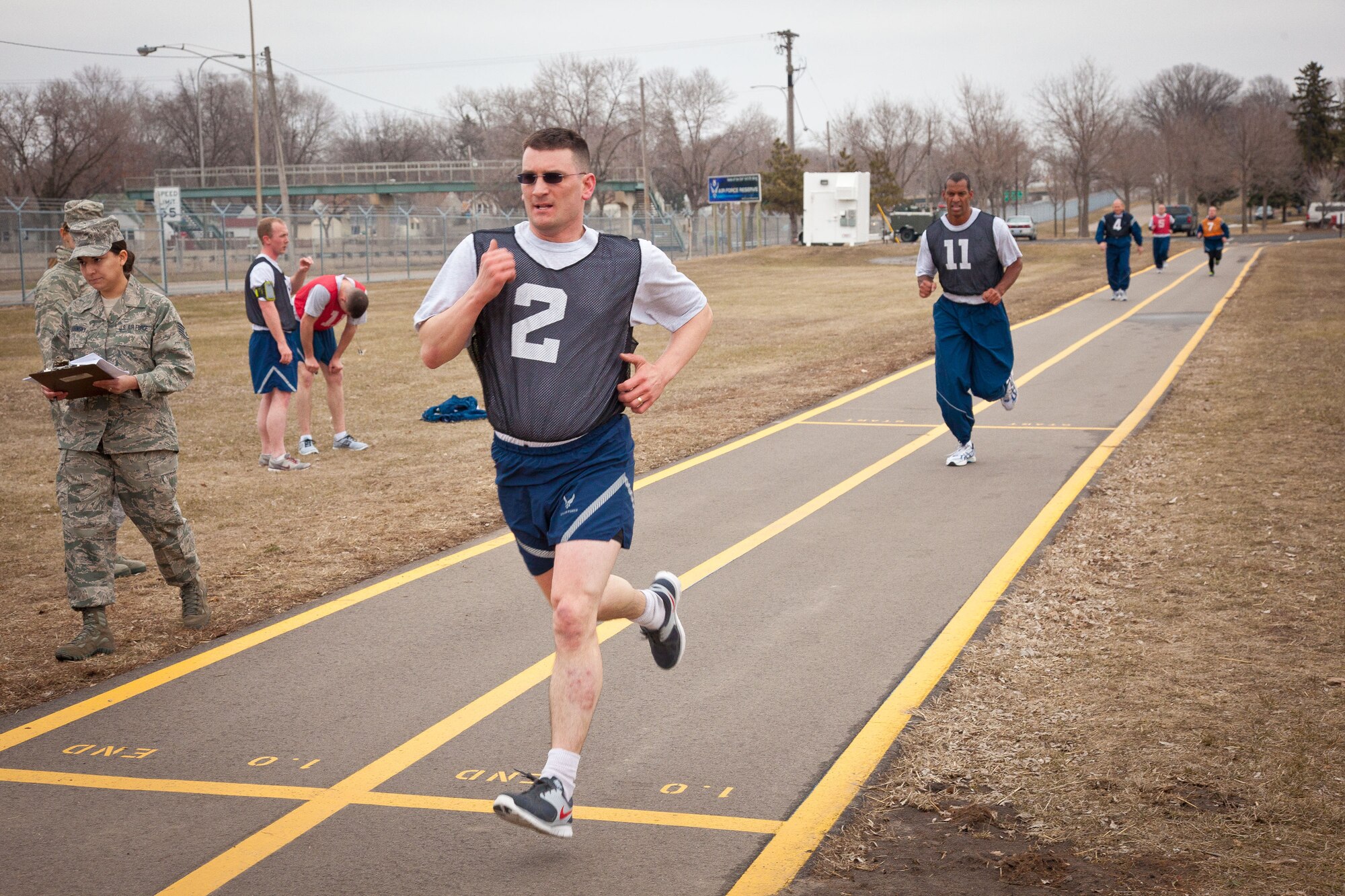Tech. Sgt. Aaron Fisher, 934th Security Forces, crosses the finish line.  Airmen from the 934th Airlift Wing complete the running portion of their annual physical fitness assessment during the April Unit Training Assembly weekend at the Minneapolis-St. Paul Air Reserve Station, Minn.  (U.S. Air Force photo/Shannon McKay)