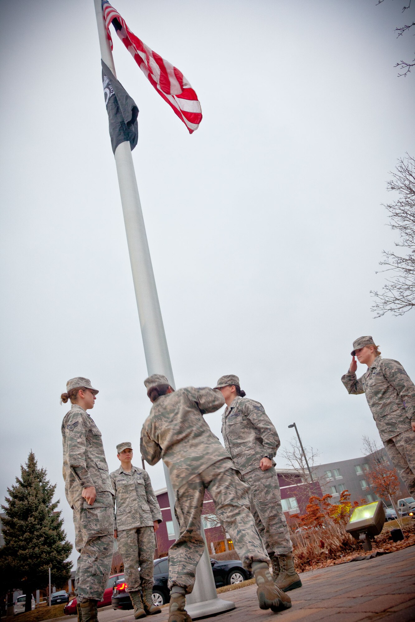 Staff Sgt. Tonya Jasninsky hoists the flag during reveille Sunday morning.  Airmen from the 934th Aeromedical Evacuation Squadron performed the flag ceremonies throughout the April Unit Training Assembly weekend at the Minneapolis-St. Paul Air Reserve Station, Minn. (U.S. Air Force photo/Shannon McKay)