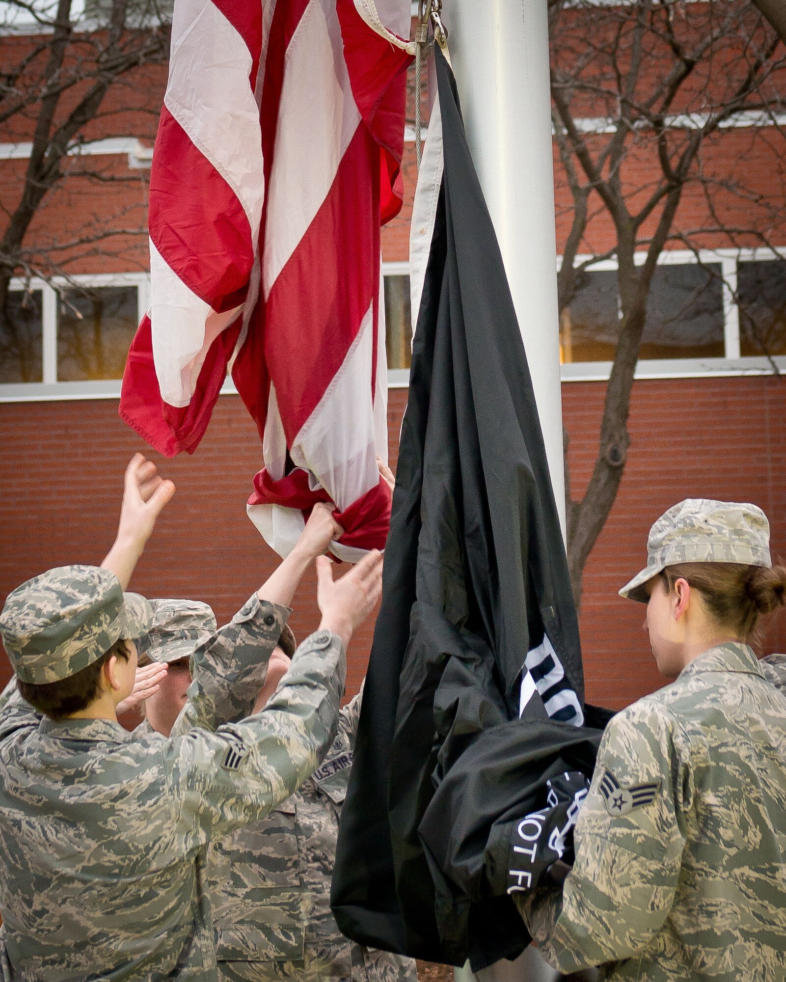Airmen from the 934th Aeromedical Evacuation Squadron raise the flag during reveille Sunday morning.  AES performed the flag ceremonies throughout the April Unit Training Assembly weekend at the Minneapolis-St. Paul Air Reserve Station, Minn. (U.S. Air Force photo/Staff Sgt. Samantha Wagner)