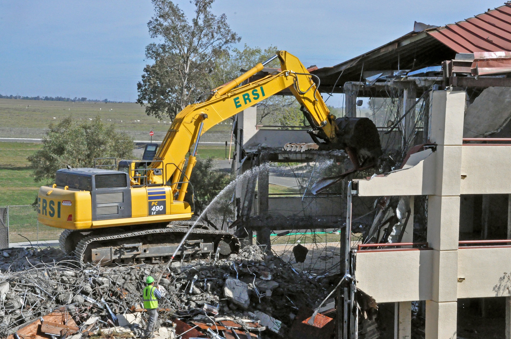 Construction workers demolish dorm 1359 March 26 on Travis Air Force Base. The dorms are being torn down to make room for new living facilities for Airmen to enhance quality of life. The demolition of dorm 1359 is expected to continue until the end of this week, then dorm 1307 will be torn down. (U.S. Air Force photo/Airman 1st Class Madelyn Brown)