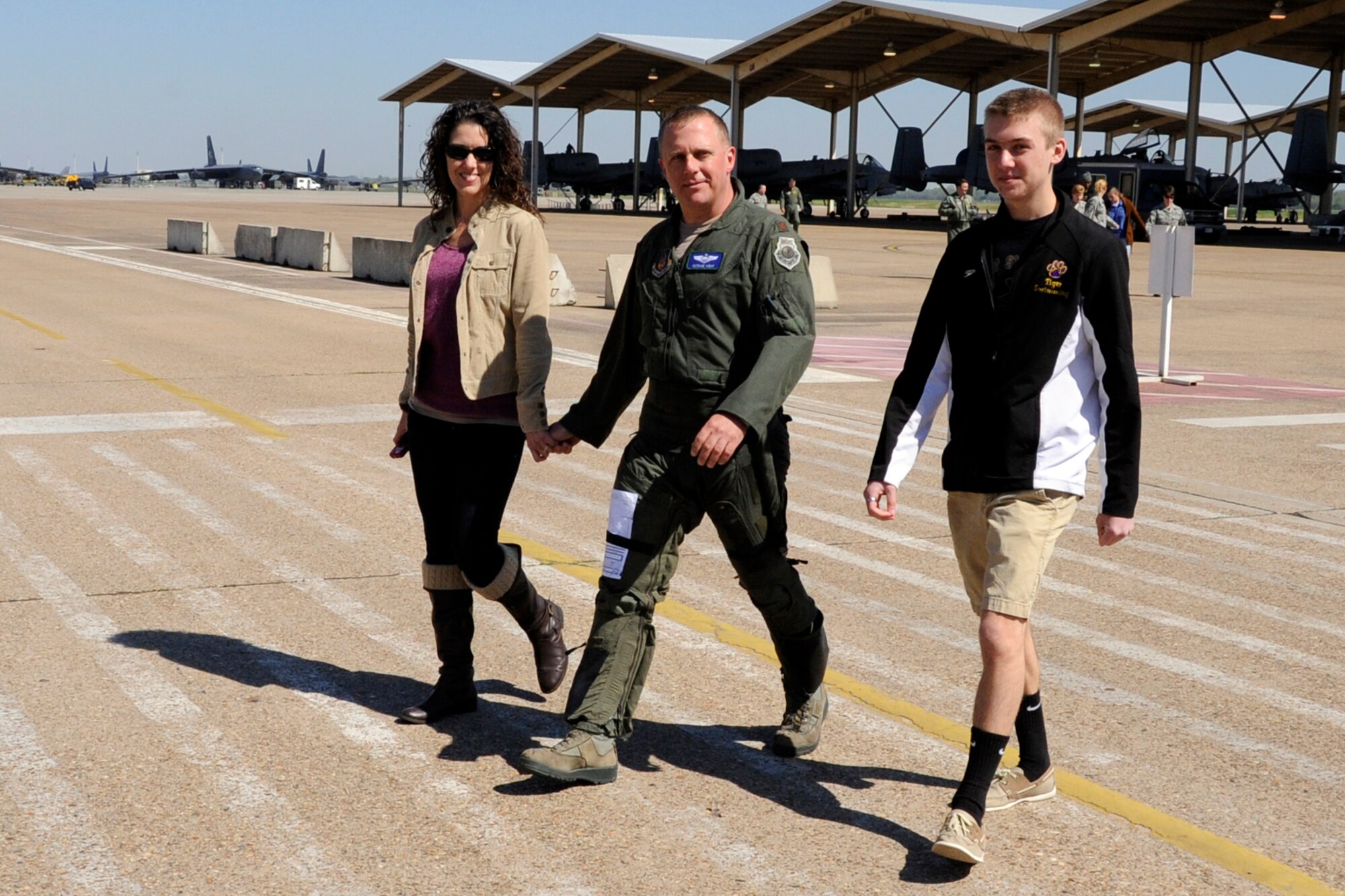 Maj. Maury Kent, his wife Cheryl and son Chase, leave the flightline after the major’s last sortie in an A-10 Thunderbolt II at Barksdale Air Force Base, La., April 5, 2013. Kent participated in a four-ship sortie for his last mission from Barksdale with three other pilots assigned to the 47th Fighter Squadron, who were also making their final flights. (U.S. Air Force photo by Master Sgt. Jeff Walston/Released)    