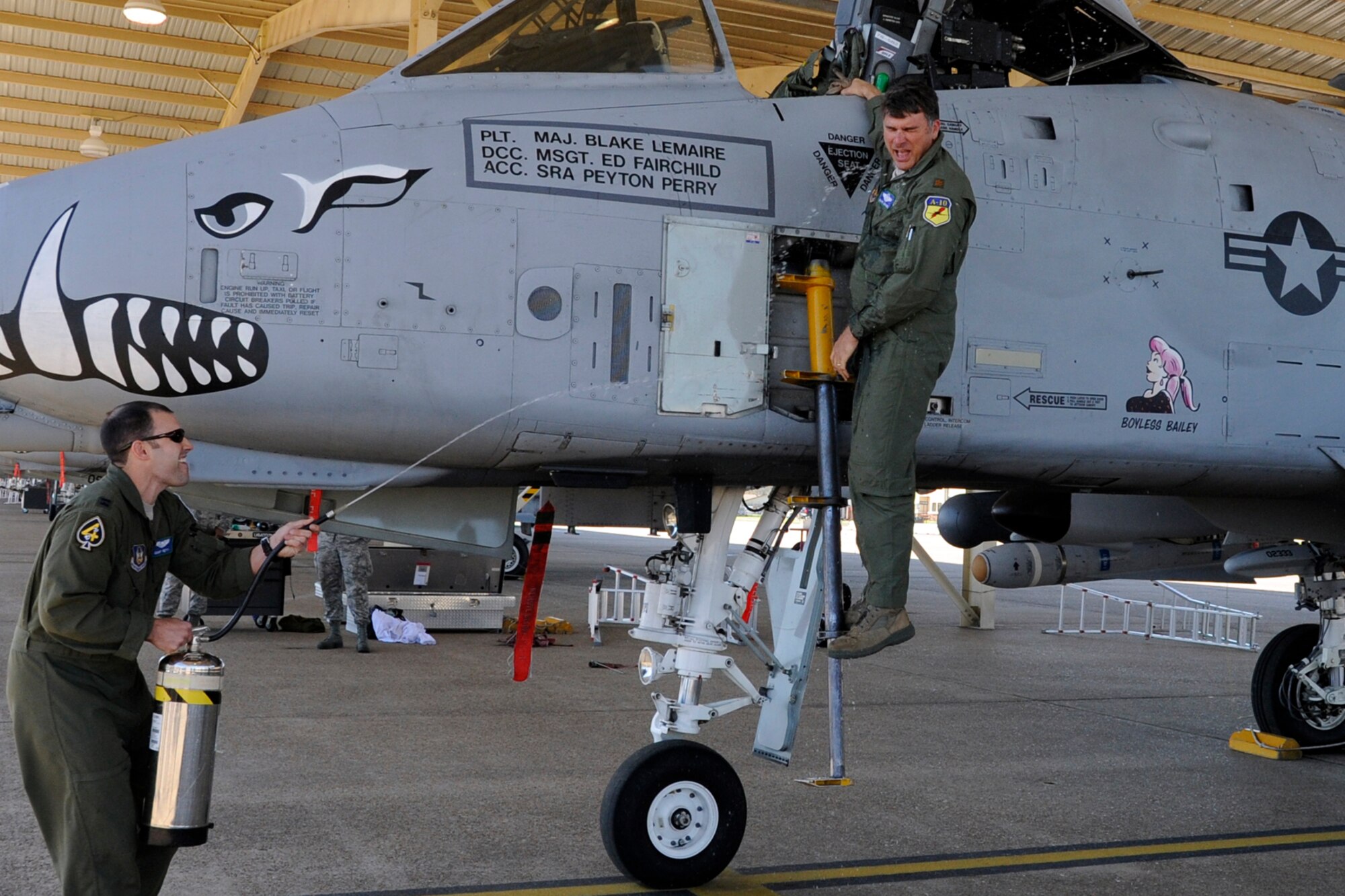 Maj. Blake Lemaire is hosed down after his last sortie in an A-10 Thunderbolt II at Barksdale Air Force Base, La., April 5, 2013. Lemaire participated in a four-ship sortie for his last mission from Barksdale with three other pilots assigned to the 47th Fighter Squadron, who were also making their final flights. (U.S. Air Force photo by Master Sgt. Jeff Walston/Released)    