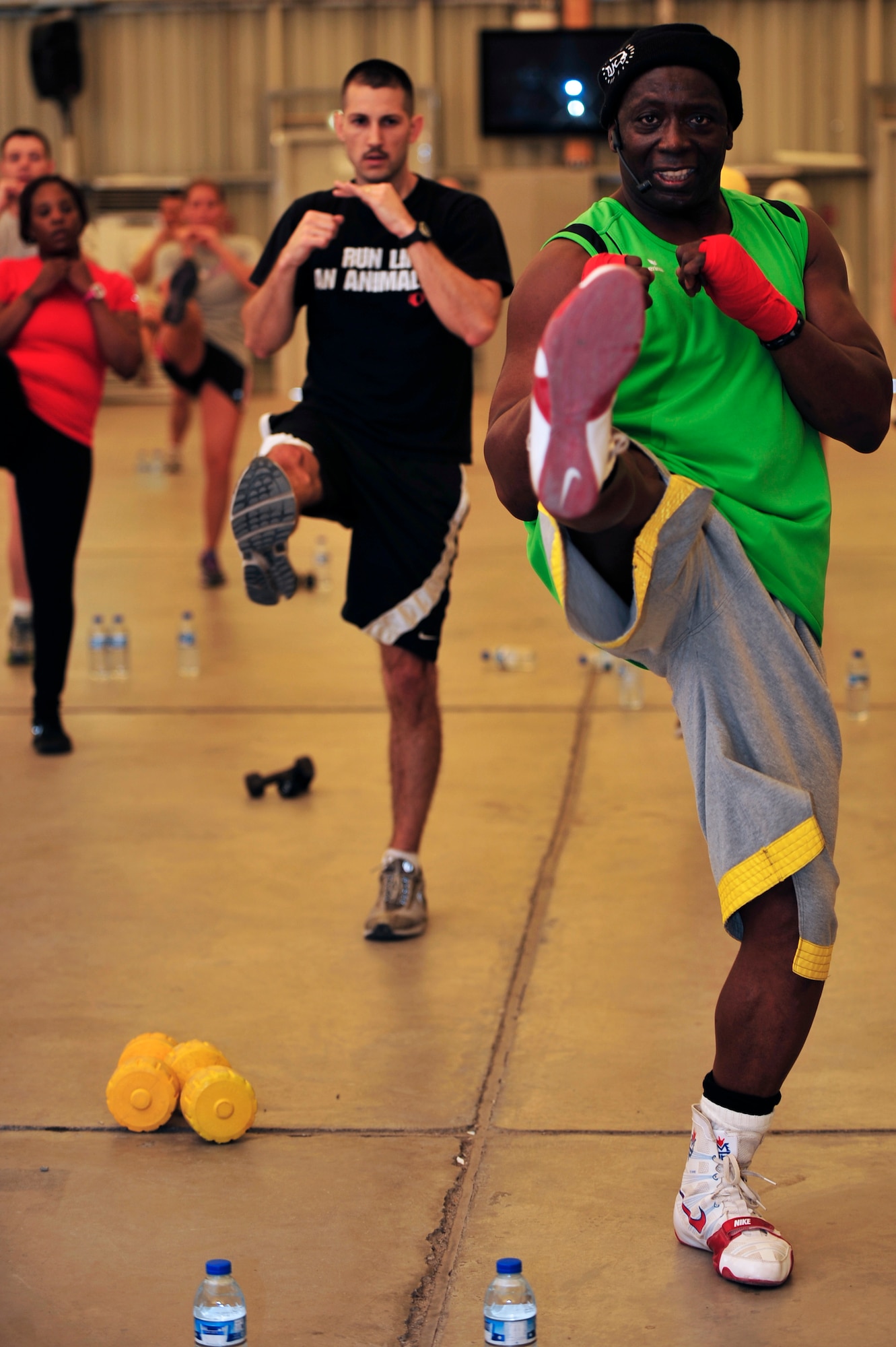 Members of the 380th Air Expeditionary Wing participate in a Tae Bo workout with creator Billy Blanks at an undisclosed location in Southwest Asia April 6, 2013. Blanks visited several bases in Southwest Asia with The American Gladiators during an Armed Forces Entertainment Fitness Tour. (U.S. Air Force photo by Tech. Sgt. Christina M. Styer/Released) 