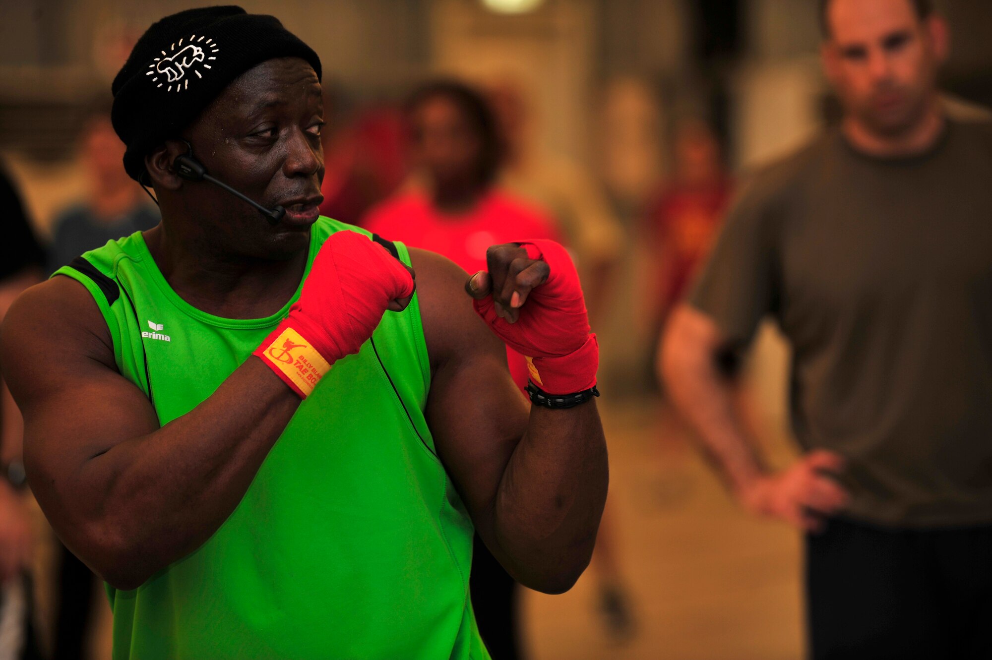 Tae Bo creator Billy Blanks demonstrates proper techniques to members of the 380th Air Expeditionary Wing at an undisclosed location in Southwest Asia April 6, 2013. Blanks visited several bases in Southwest Asia with The American Gladiators during an Armed Forces Entertainment Fitness Tour. (U.S. Air Force photo by Tech. Sgt. Christina M. Styer/Released) 