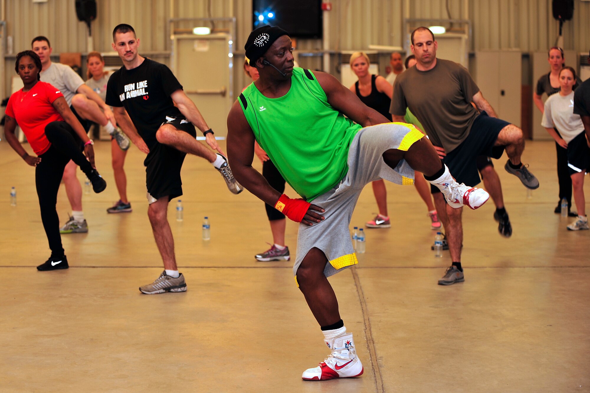 Members of the 380th Air Expeditionary Wing participate in a Tae Bo workout with creator Billy Blanks at an undisclosed location in Southwest Asia April 6, 2013. Blanks visited several bases in Southwest Asia with The American Gladiators during an Armed Forces Entertainment Fitness Tour. (U.S. Air Force photo by Tech. Sgt. Christina M. Styer/Released) 