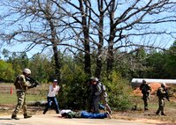 Members of the 919th Security Forces Squadron retrieve a missing American during an extraction exercise at Duke Field, Fla., April 6. The Security Forces Airmen executed this training exercise with the trainees from the Development and Training Program. The DTP is an Air Force Reserve Command introductory program to help recruits prepare for military life prior to going to basic military training. The trainees were given a first-hand view of the procedures performed to recover American personnel from a downed aircraft in a hostile environment. They were able to participate as local nationals and the missing American personnel. (U.S. Air Force photo/Tech. Sgt. Cheryl L. Foster)